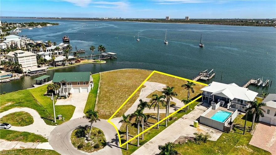 Mother Nature’s Playground Meets the Ultimate in Luxury—Your future Estero Bay estate begins here. Discover a once in a lifetime opportunity to own a pristine, sprawling waterfront parcel on the prestigious North End of Estero Bay. This large, vacant lot offers nearly 90 feet of direct waterfront access with Gulf access just steps from your front yard—perfect for boaters seeking both convenience and exclusivity. Located on a peaceful cul de sac within the exclusive Matanzas Court neighborhood, this property provides the perfect blend of seclusion and vibrant island living. Imagine waking up to breathtaking sunrises over peaceful waters, enjoying evening strolls along the endless beach, and having effortless access to the Gulf from your own backyard.The seawall spans 89 feet across the rear of the property—storm damage to the dock and lift remains for future remediation. Enjoy the North End locatoin with just a short 5-10 minute walk to Times Square, Margaritaville, beachy restaurants, shops, and nightlife. The dedicated turn lane from the Matanzas Bridge ensures seamless high season access. Seeking a larger estate? The connecting Bayfront lot, (MLS #2025007037) with approved plans offers the opportunity for a larger footprint—perfect for creating an expansive compound or multiple residences. Elevate your living with direct access to the Gulf, unmatched privacy, and endless natural beauty—all within reach of Southwest Florida’s most vibrant hotspots. Imagine hosting unforgettable gatherings, indulging in picturesque sunrise mornings, or exploring the Gulf’s islands at your leisure. This is more than just land—it’s a rare opportuntiy to craft a custom coastal retreat beyond ordinary expectations. With over 15 commercial projects approved or underway across the island, now is the ideal moment to secure this special waterfront opportunity!