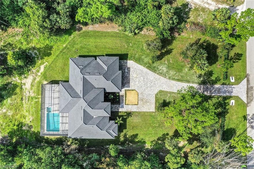 Discover an exceptional new construction estate nestled on 2.27 acres in the desirable Weber Woods community of Golden Gate, Naples. This beautifully designed 4-bedroom, 3-bathroom residence offers approx. 2,669 sq ft of refined living space with a thoughtful layout perfect for modern living and entertaining. From the moment you arrive, privacy and tranquility are evident with lush landscaping and a Calusa hedge at the front of the property. Inside, the home showcases high-end finishes, including a spectacular quartz waterfall island, sleek modern cabinetry with under-cabinet lighting, and an open great-room design that flows effortlessly throughout the living spaces. The spacious master suite is a retreat of its own, featuring a large shower, soaking tub, and two generous walk-in closets ideal for comfort and organization. A versatile den adds valuable flexibility for a home office, study, or media room. Outdoor living is exceptional, with a salt-water pool and heated spa, screened lanai, and a fully equipped outdoor kitchen, making it ideal for hosting gatherings or enjoying peaceful Florida evenings. Additional features include a 3-car garage, full-house reverse osmosis water system, impact-rated windows and doors, tile flooring throughout, and a well-appointed kitchen with quality appliances. Located in a non-gated, serene setting yet close to Naples’ top schools, shopping, dining, and beaches, this property blends privacy with convenience a rare opportunity in today’s market.