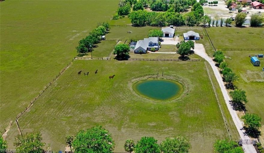 ATTENTION EQUESTRIAN ENTHUSIASTS, HOBBY FARMERS and NATURE LOVERS, seeking the ideal country lifestyle without sacrificing convenience! This one-of-a-kind property spans 4.7 acres and features a 2-story home with 4 bedrooms, 2 Office/Dens, and 3 bathrooms, a well-appointed 5-stall barn, pole barn, cross fenced pastures, and a fishing pond! Located in a highly desirable area for horse owners, the property is within close proximity to animal veterinary clinics, feed stores, several horse trail parks, and venues that accommodate all disciplines of horsemanship. Within minutes to shopping & dining and the conveniences of the Babcock Ranch community, this beautiful home has 2596 sq ft under air, featuring a 1st-floor master suite, 1st-floor office/den, lovely formal living room with a wood burning fireplace, a spacious family room, and a large gourmet kitchen with granite countertops, white cabinetry & butler’s pantry area. New luxury vinyl plank flooring extends throughout the entire 1st floor living areas, creating a clean, updated look throughout. Upstairs you will find 3 additional bedrooms, including a large guest suite with a separate open room that could be partitioned to a 5th bedroom or additional den/office, and a spacious bathroom with 2 sinks, separate tub & shower. The home is equipped with a high output reverse osmosis water filtration system for added convenience and water quality. At the heart of the property is the well-appointed horse barn equipped with power & water, which includes 5, 12'x12' stalls, with a removable wall between 2 stalls to create a larger birthing stall when needed. A dedicated wash rack and grooming bay, spacious feed room & air-conditioned tack room provide the amenities horse owners value most. Water lines run throughout all pastures, simplifying daily care and also provides irrigation for the raised garden beds. An additional pole barn provides valuable covered storage for equipment, tractors, personal vehicles, or RV/boat storage, hay and supplies...further enhancing the property's overall functionality. Designed with ease of use in mind, the property offers ample parking, easy trailer maneuverability, and dedicated space for horse trailers & equipment...a major advantage for the active equestrian or hobby farmer! After an active day, come and enjoy your afternoon iced tea or favorite evening beverage relaxing on your spacious screened lanai, overlooking your heated pool & waterfall spa, taking in the peaceful outdoor setting...perfect for relaxing or entertaining, while overlooking the beautiful, lush pastures! Take a swim in your sparkling pool and ease into your private therapeutic spa and feel the peace and quiet of the balmy nighttime breeze under the moon and stars...this is peaceful country living at its finest! Come see this wonderful property and take advantage of this rare opportunity to own acreage and a beautiful, spacious home that offers the perfect balance of rural charm and modern convenience!