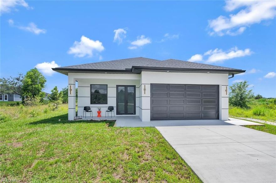 Located on a spacious 1.64-acre upland corner lot in Golden Gate Estates, this efficient single-story new construction home offers ample space to drive to the back of the property—perfect for boats, RVs, or heavy equipment. The home features a unique and functional floor plan with a walk-in closet, impact windows and doors, modern light fixtures, and an outdoor kitchen. Enjoy peaceful natural surroundings with plenty of room to add a pool. No HOA fees. Photos are of a similar model; property is currently under construction.