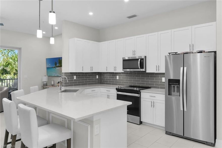 LOWEST PRICED HOME IN ANTILLES!!! This light and bright second floor classic coach home features 3 bedrooms and 2 bathrooms and was built in 2023. High ceilings residence with partial water view consists of almost 2000 sq ft , this spectacular residence features a one-car garage and a spacious master bedroom,with an elegant ensuite featuring an extended floor to ceiling tile in shower and flooring, dual sinks, and an expansive walk-in closet. Additionally, you'll discover a generously proportioned guest bedroom, a versatile office that can easily be converted into a third bedroom and a well-appointed laundry room furnished with a washer, dryer. The interior is complemented by stainless steel appliances and a beautiful view from lanai. The master bedroom is big, with an amazing walk-in closet and a big bathroom, while the guest bedroom offers a big closet and a sunny room. The screened lanai, accessible through sliding doors from the living room allows one to simply relax or even dine outside. Key features of this meticulously designed residence include impact doors and impact glass, extended and upgraded kitchen countertops, new dimmer switches added to kitchen area, wooden blinds installed in all windows, upgraded light fixtures over dining room table. Guest bedrooms have been upgraded from carpet to tile, new ceiling fans in master/living room, new fan added to lanai, glass shower enclosures, and added mirror framing in both bathrooms. Outside, lush tropical landscaping thrives with automatic irrigation, and a paver driveway leads to a charming paver entry walkway. Antilles Naples is a serene oasis, enveloped by a lush tropical landscape. This oasis  is just minutes away from the white sandy beaches of Marco Island, the Isles of Capri, and a mere 25-minute drive from the gourmet dining and upscale shopping destinations of downtown Naples.