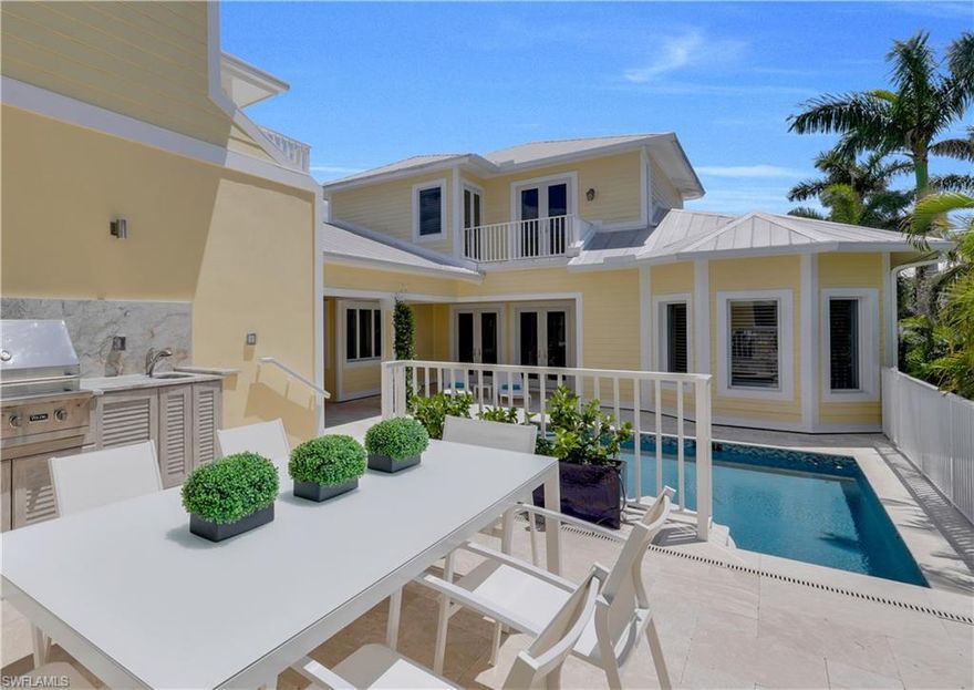 Welcome to the ultimate Old Naples home, offering an incredibly luxurious lifestyle. Recently designer upgraded in 2017, to the highest in quality and construction, this five bedroom home is perfectly situated on one of Old Naples’ most desirable streets, close the beach and just a stroll to the restaurants and shops of Third Street South in historic downtown Naples. Offering 4,275 square feet of living under air and 6,285 total square feet, this home is finished with the very finest of details and finishes. Rooms throughout are designed for comfortable living. Highlights include a spacious living area combined with a formal dining area adjoining a custom handcrafted gourmet kitchen. The private first-floor master suite is spacious and the master bath is extraordinary. A second bedroom or office is en-suite and a private guest cabana is perfect for guests. The second floor features two generous en-suite bedrooms. Car enthusiasts will enjoy the 5 plus car garage. And, a spacious lanai with pool and spa, a covered seating area with linear fireplace and separate dining terrace with a summer kitchen is ideal for entertaining.