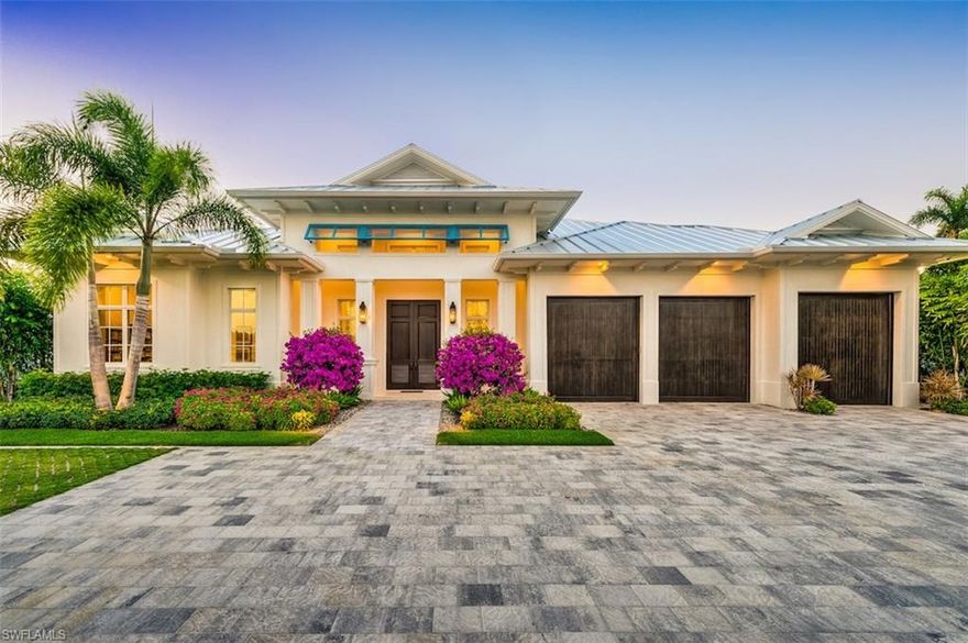 With spectacular golf course views in the Moorings, this 4,221 sq. ft. Knauf-Koenig-built five bedroom (all en-suite) gem is a shining example of what the Naples lifestyle is all about. This open-concept Falcon Design home features gorgeous detailing with warm Legno Bastone wide plank wood flooring under white beamed ceilings for a modern Florida feel. The great room features a dramatic 20ft vaulted ceiling and 10ft French doors which open onto the covered lanai, pool and golf course. The kitchen has Ruffino cabinetry, Wolf and Sub-Zero appliances, two dishwashers and a walk-in pantry. An elegant dining area with contrasting Ruffino beverage bar makes the space perfect for both everyday and entertaining. A full Control4 system for TVs, music, lighting, window shades and security cameras, makes this a truly smart home. The master bedroom opens onto the stunning pool area and features a spacious Ruffino closet (guest bedrooms have California Closets). The outdoor living area includes a gas-heated saltwater pool and spa, a beautiful outdoor kitchen, and a lanai area with fireplace, protected by roll-down screens and storm shutters. This recently completed home is truly move-in ready.