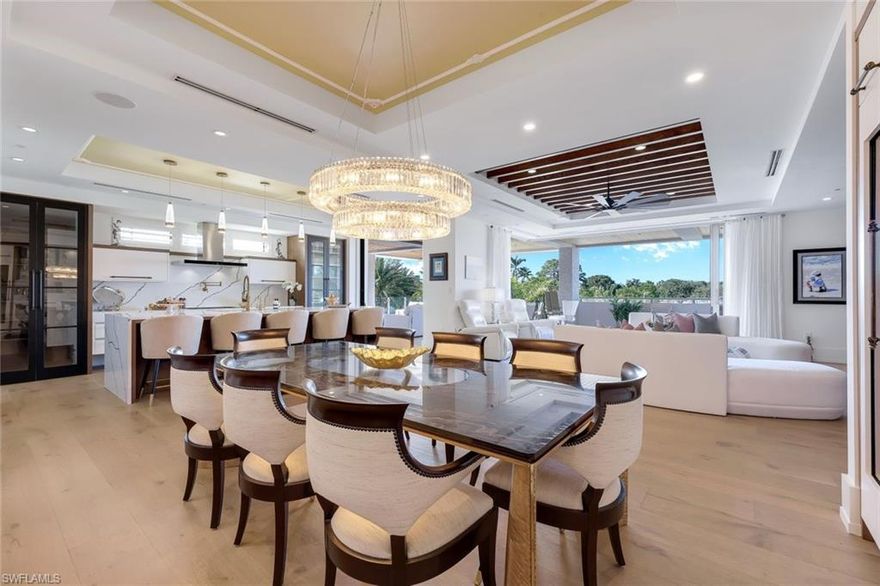 Own the entire 2nd floor in the Exclusive, Private and Rare 275|8th Building! Built in 2022 and rarely used, there are only 2 Luxury Condominiums penned by MHK Architects, with interiors designed by Charles Design Studio. This refined property is completely unique to Naples offering a Boutique Condominium project with each unit occupying an entire floor! Floor to ceiling glass walls open to balconies on all sides.  Located steps to 5th Ave shops, cafes and fine dining, the residence offers 3 bedrooms, a chic office behind pivot doors, 3.5 baths, a private garage with lift for 2 cars, plus a private designated carport and nearly 5,000 Sq ft. of luxury living. Additionally, the 275 Building shares the full amenity package just steps to its sister condo, The Mark On 8th.  A spectacular resort pool and spa, work out room, golf simulator and party room with bar complete this one-if-a-kind downtown city package. The home boasts an open floor plan with an expansive 1,350 sq ft patio with fireplace, fully equipped island kitchen with gas cooktop and gorgeous finishes, large custom pantry with built-in coffee maker, unique custom trimmed cabinetry, sophisticated wet bar, a sun filled glassed great room with beautiful beamed ceilings, a private office, and European hardwood floors throughout the home. The Master suite has two walk-in closets, custom vanities, a luxury tub, dual walk-in glass walled showers surrounded by an ivy-covered sun wall. French doors open to a double balcony for morning coffee and sunrises off the two guest bedrooms.  Buyers can expect a high level of privacy, quality construction and innovative design. The first floor is occupied by a small quiet bank. This is fantastic downtown City Living at its best!