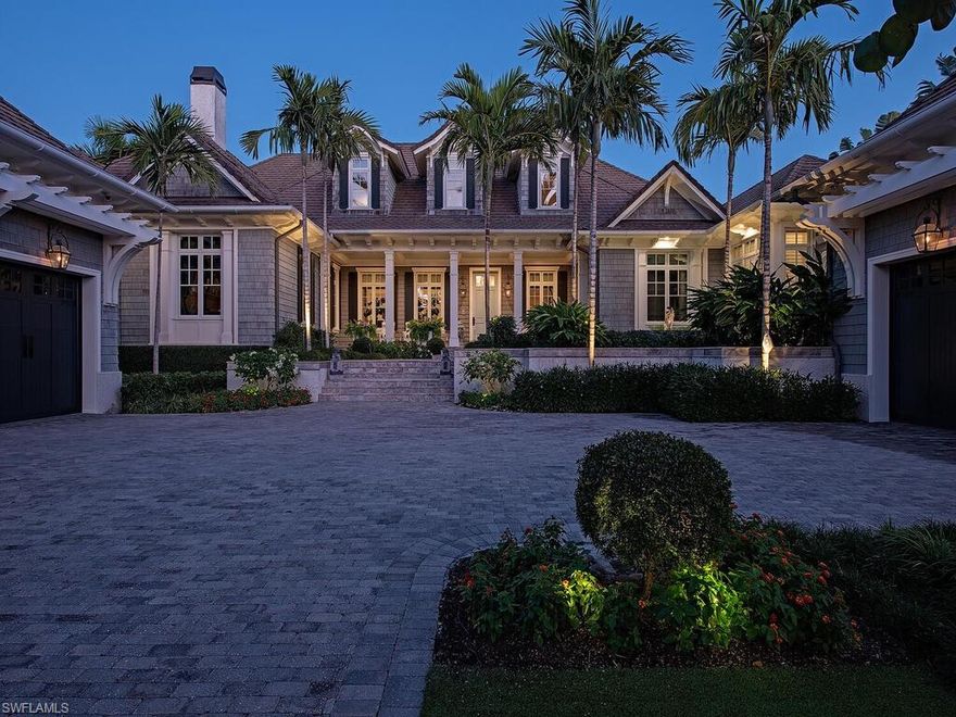 Quietly situated at the southernmost end of Gulf Shore Boulevard South, directly across from beach access, this exceptional Olde Naples estate is a true crown jewel, spanning more than one-half acre. Designed by John Cooney of Stofft Cooney Architects and meticulously refurbished throughout, the residence reflects uncompromising craftsmanship and timeless sophistication and can be acquired turnkey furnished for immediate occupancy. From the moment of arrival, the home makes a lasting impression. Flickering gas lanterns, a gracious front porch, and classic symmetrical architecture accented by exquisite millwork create an inviting sense of elegance. Inside, refined finishes abound, including mahogany front doors, rift-sawn white oak flooring, and a striking vaulted ceiling detail upon entry. The living room’s balanced symmetry and detailed millwork flow seamlessly into the gourmet kitchen and dining area, anchored by a 60" Wolf dual-fuel range featuring six burners, an infrared charbroiler, and an infrared griddle. Additional highlights include a Sub-Zero side-by-side refrigerator and freezer, integrated refrigerator drawer systems, and two Miele dishwashers—perfectly suited for both everyday living and entertaining. Thoughtfully curated spaces throughout the home include a bespoke media room with soundproofed walls and a Savant sound system, a handsome study with custom built-in display cabinetry overlooking the pool, a fully reimagined bar and library, and a dedicated fitness studio complete with a steam shower—each space designed for both function and refined living. The estate is comprised of five well-appointed bedrooms, four of which feature en-suite baths, offering refined accommodations for both residents and guests alike. The Master Suite and Bath offer a true private retreat, enveloping you in comfort from head to toe. A tranquil sitting area overlooks the spa and pool, providing a serene backdrop for rest and reflection. Crown moldings and elegant casings throughout enhance the sense of refined craftsmanship, creating a space that feels like a peaceful escape—while remaining unmistakably at home. Following a complete renovation inside and out, the outdoor living spaces are equally compelling. An expansive, oversized porch is designed for rest and relaxation, offering an exceptional poolside setting framed by a preserved Wild Oak tree—an enchanting natural centerpiece that enhances the estate’s sense of serenity and timeless charm. Additional elevated improvements include two side-mounted car lifts, whole-house generator, dual dehumidification systems, a steam shower within the fitness studio underscoring the home’s exceptional level of care, resilience, and thoughtful investment.