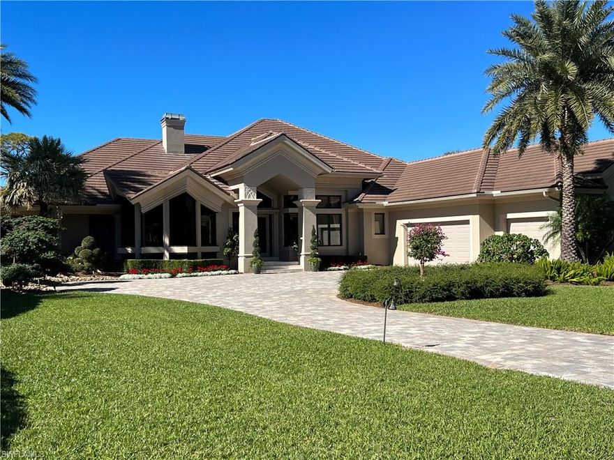Custom home on a premier lot in Spring Ridge at Bonita Bay with lake and golf course views!
