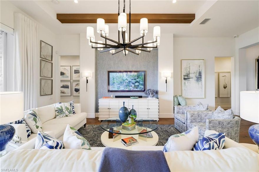 Experience refined waterfront living within the gates of Miromar Lakes Beach & Golf Club, where luxury and lifestyle come together in a truly special setting. Just moments from the renowned Arthur Hills signature championship golf course, this rarely available designer grand estate offers an exceptional blend of comfort, sophistication, and effortless indoor outdoor living.

With bright western exposure that captures breathtaking sunsets over the water, this custom-built residence by Arthur Rutenberg Homes showcases four bedrooms and five and a half baths across two gracious levels. The main floor is thoughtfully designed for gathering and entertaining, featuring an open concept living and dining area, a gourmet kitchen with walk in pantry, reverse osmosis water system, and seamless access to a spectacular outdoor retreat. The expansive lanai invites you to relax beside the pool and spa, unwind by the stacked stone fireplace, or host memorable evenings in the fully equipped outdoor kitchen and bar complete with a pizza oven and Evo teppanyaki grill. A well-appointed pool bath enhances the ease of outdoor living.

Inside, refined finishes and exquisite fixtures elevate every space, complemented by Control4 lighting throughout the first floor and integrated surround sound that create the perfect ambiance for any occasion. The serene primary suite offers a spa inspired bath, creating a private sanctuary, while a versatile bedroom or home office completes the first level. Upstairs, two guest suites with en suite baths are complemented by a comfortable sitting area with its own refrigerator and wet bar, providing privacy and flexibility for family or visitors.

An oversized two car garage with epoxy flooring and air conditioning adds to the home’s impressive list of amenities.

This remarkable waterfront estate presents not only an extraordinary residence, but also the opportunity to embrace the unparalleled beauty, warmth, and resort inspired lifestyle that make Miromar Lakes truly special.