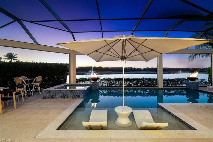 Nestled within the prestigious community of Miromar Lakes Beach & Golf Club, this extraordinary waterfront retreat seamlessly blends timeless elegance with the ease of resort-style living. Perfectly positioned near the acclaimed Arthur Hills Signature Championship Golf Course, this rare custom estate by Arthur Rutenberg Homes offers an exceptional balance of luxury, comfort, and refined design.

Bathed in coveted western exposure, the residence captures stunning sunset views across the water and spans two beautifully appointed levels with four bedrooms and five-and-a-half baths. Designed with both entertaining and everyday living in mind, the main floor features expansive open-concept living and dining spaces, a chef-inspired kitchen with walk-in pantry, reverse osmosis water system, and effortless transitions to the outdoor living areas.

The resort-caliber lanai creates a private oasis, complete with a sparkling pool and spa, stacked-stone fireplace, and an impressive outdoor kitchen and bar featuring a pizza oven and Evo teppanyaki grill. A dedicated pool bath further enhances the seamless indoor-outdoor lifestyle.

Inside, sophisticated finishes and designer fixtures define every room, while Control4 smart lighting throughout the first floor and integrated surround sound provide elevated comfort and ambiance. The luxurious primary suite serves as a tranquil escape with a spa-like bath designed for relaxation, while an additional first-floor bedroom or office offers flexibility to suit your lifestyle.

Upstairs, two spacious guest suites each feature private en-suite baths, accompanied by a welcoming lounge area with a wet bar and refrigerator—ideal for hosting family and guests with comfort and privacy.

Additional highlights include an oversized, air-conditioned two-car garage with epoxy flooring and extensive premium upgrades throughout. More than a home, this remarkable estate presents a rare opportunity to experience the unmatched beauty, prestige, and waterfront lifestyle that define Miromar Lakes living.