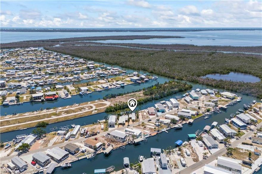 Direct Gulf Access charming home! Gorgeous west facing view of nothing but mangroves and sunsets! Experience the ultimate in waterfront living with this beautifully remodeled two-bedroom, two-bathroom home, ideally situated on a peaceful canal with direct Gulf access and beautiful furnishings Surrounded by lush mangroves, this property offers a perfect blend of island charm and modern comfort. This turnkey furnished home features an open-concept layout filled with natural light, thoughtfully designed with coastal finishes that reflect a relaxed, tropical lifestyle. The main living areas and outdoor spaces offer uninterrupted views of the serene mangroves, creating a true sense of privacy and connection with nature. Located in a walkable, bike-friendly neighborhood, you're just minutes from scenic trails, local dining, and the water adventures that make Gulf living so desirable. Whether you're enjoying the tranquil sounds of nature from your private deck or launching a kayak right from your backyard, this home invites you to slow down and embrace island life. There is a 160 mile Great Blue Calusa Kayaking and paddle boarding marked water trail literally in your back yard! You are just a hop, skip and short golf cart ride to the many restaurants, bars and marinas that make St. James City a boating and fishing mecca! Perfect as a full-time residence or a weekend escape, this canal-front property is ready to welcome you to your slice of paradise. Schedule your private showing and experience the best of waterfront living.