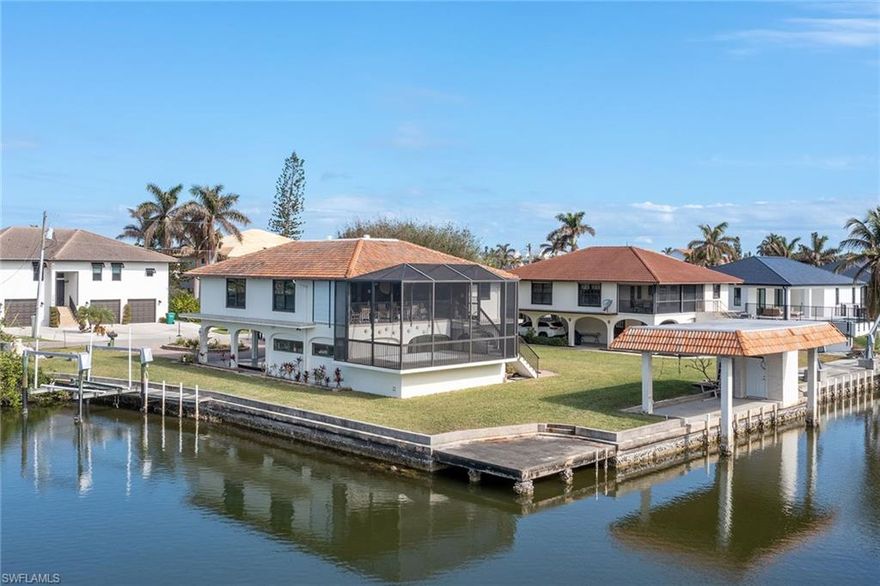 A rare opportunity to own a stunning waterfront lot in the beautiful Little Hickory Shores community. A corner lot with wide lot space and direct gulf access, you can embrace the ultimate Florida lifestyle. The positioning of the lot offers immediate access to the serene waters of Little Hickory Bay, where fishing from your floating dock or launching your canoe and kayaks promise endless outdoor enjoyment. For boating enthusiasts, the convenience of a 15-minute ride to the gulf without the obstruction of any bridges through Wiggins Pass makes this location special. The property features two boat lifts, including a deeded boathouse. In just a short distance you will also find the vibrant Coconut Point Mall and Mercato Shops, as well as the SWFL International Airport, all within easy reach. For those who love the beach, you're less than a mile away and can enjoy a leisurely 10-minute bike ride to the world-renowned shores of Bonita Springs. Don't miss out on experiencing the charm of Bonita Springs' historic downtown, which is quickly becoming one of Southwest Florida's hottest destinations. This hidden gem in Little Hickory Shores is not just a place to live. It's an invitation to experience the essence of Florida living at its finest.