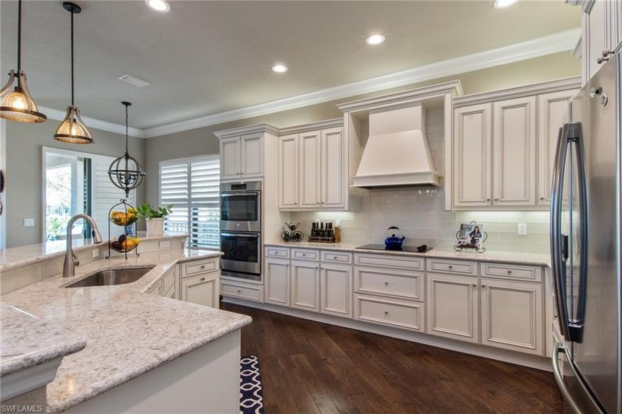 H.13747 Here's a rare find with this "Model-Like"gorgeous home on an OVERSIZED LAKE LOT with POOL & SPA. Enjoy breath taking sunsets from your lanai in this spacious like-new 4 bed+/4 bth home boasting over $200,000 in upgrades, including wood floors, hurricane impact windows and doors, retractable lanai screens, plantation window shutters, crown molding, built in closet organizers, built-in entertainment center, fenced yard, gourmet kitchen with range hood, granite, and stainless steel appliances.  This convenient floor plan features 2nd level bonus room with built in Murphy Bed and full bath. Riverstone is a highly sought after new community featuring the best amenities package, including spectacular lifestyle complex with resort style pool, shade cabanas, tiki hut, lap pool, water play area, fitness center, 5 lighted Har-Tru tennis courts, basketball courts, and 13,000 sqft clubhouse with full time activities director! This exclusive community is located in “A rated” school district and features a grand gated entrance with 24 hour manned security, with very reasonable monthly HOA that includes all this, plus home lawn care and irrigation. Schedule a showing before it is gone!