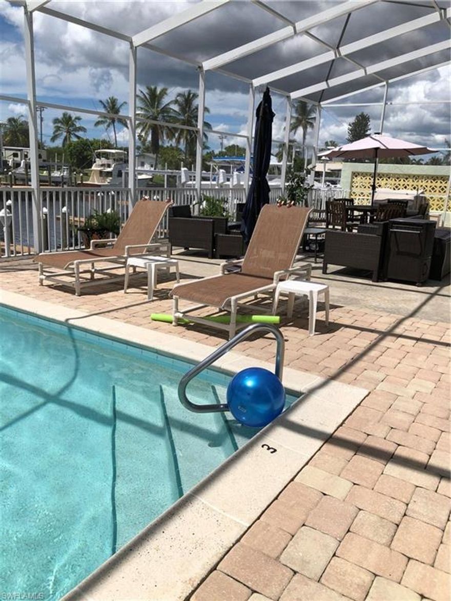 Rare opportunity to own a direct Gulf access, first floor condo. A large heated pool. slip space, turn key furnished, lovely tropical decor, granite countertops.  Condo building has had excellent management with a new metal roof, railings, light fixtures, pool refinished and so much more.  Only 10 units in building share large screened pool/lanai enclosure.  Walk to local pubs, restaurants and marina.  High end seafood shop next door. Wonderful sunsets!