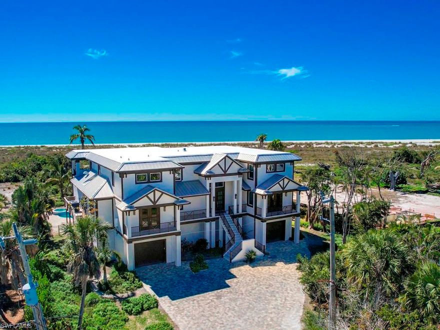Step into the definition of coastal elegance with this custom-built masterpiece, completed in 2021, directly located on the shores of the Gulf of Mexico in the sought-after Chateaux Sur Mer neighborhood. This 5-bedroom, 5.5-bathroom residence, inclusive of a home office, is a celebration of top-tier craftsmanship and luxury. The chef's kitchen with imported granite and exquisite tilework sets the stage for culinary excellence. An open-concept living space features a stunning gas fireplace, creating a warm and inviting atmosphere. The living area seamlessly extends onto a porch, where the pool and the Gulf of Mexico beckon beyond—a true sanctuary for enjoying nightly sunsets. The primary suite boasts a morning kitchen, deck access, and a spa-like bathroom adorned with a tub, separate shower, and custom tilework. The convenience of a large garage with abundant storage space, coupled with an elevator providing access to all levels, ensures both practicality and luxury. Indulge in beachfront bliss with a private path leading to the pristine shores. This residence is a harmonious blend of modern sophistication and coastal charm.