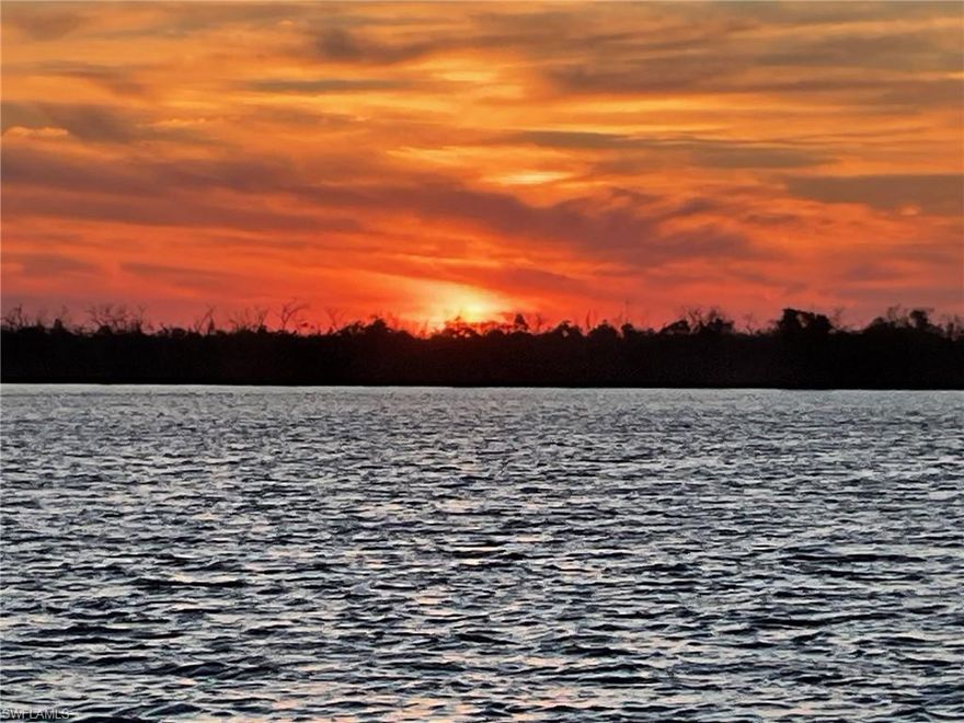 Absolutely stunning property!  From the polished travertine throughout the entire home, modern upscale furniture-grade cabinets (Thomasville) with an incredible amount of storage, to the unmatched phenomenal sunsets every night---from your pristine pool if you'd like!  THIS is the island home we dream of!  The kitchen boasts gorgeous, white Cambria quartz, including a huge island with spectacular waterfall design that's seen the moment you walk in the door.  All appliances are new GE Profile and the microwave utilizes Advantium technology making it dual purpose as a second wall oven as well.  Bathrooms have been beautifully upgraded and all windows feature custom blinds, some electric.  The resort-style pool has an integrated spa at one end and an integrated water feature at the other, with unobstructed views across the bay!  The entire home is concrete block and secure with impact windows and doors, and would be a perfect candidate for flood panels----the home flooded minimally and was professionally remediated.  Solar panels allow for year around average electric bills of $110 with credits enrolled in the LCEC Net Metering Program.  New AC and an additional mini-split system in the garage expand your ability to "project through all seasons" as well in the oversized garage.  Priced to sell, this home is a must-see.