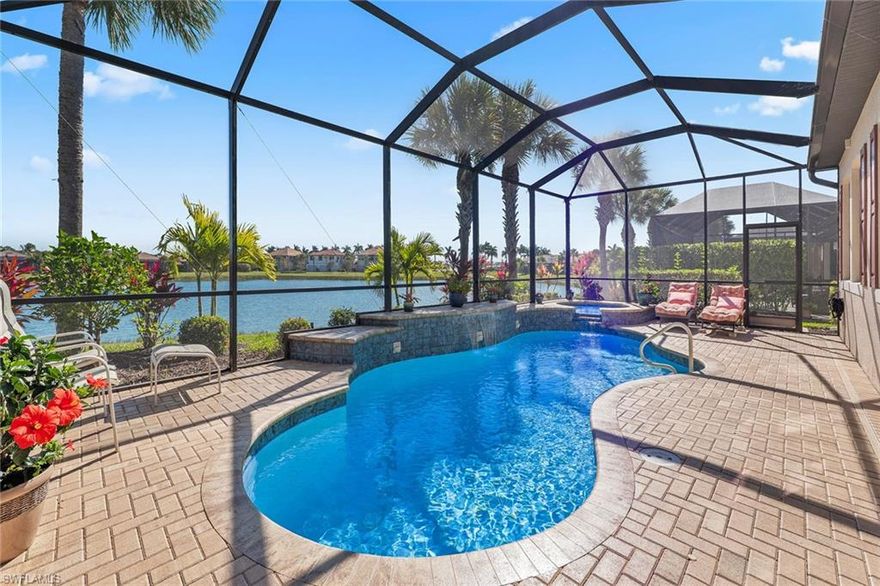 Welcome to Artesia, one of Naples sought-after upscale gated communities, known for its luxurious amenities and active lifestyle. This stunning waterfront Martinique model, built by acclaimed WCI, showcases breathtaking eastern sunrise views on an oversized pie-shaped lot and an array of premium upgrades throughout. Designed with elegance and functionality in mind, this residence features impact-resistant windows and doors throughout, a custom saltwater pool with spa, an outdoor kitchen featuring a grill, refrigerator, dishwasher, sink with disposal, and more. The upgraded kitchen is a chef’s dream, featuring high-end stainless-steel appliances including a French-door refrigerator and newer microwave (2024), a walk-in pantry, upgraded Merillat cabinetry with pull-out shelving and 42-inch uppers, upper and under-cabinet lighting, custom tile backsplash, granite countertops, and a breakfast bar. The elegant great room showcases a tray ceiling, custom crown molding, and tranquil lakefront views, which continue into the serene and expansive master suite. The spa-like master bath offers a dual-sink vanity with Arabescato Bianco marble countertops, a frameless Euro-glass shower, private water closet, and a spacious walk-in closet with custom storage system. Guest accommodations include two generously sized bedroom suites, each with its own private en-suite bath. Outdoor living is enhanced by a custom free-form saltwater pool with waterfall features and a newer integrated spa that was added in 2021, complemented by a newer saltwater generator (2024) and full remote smartphone control. Additional premium upgrades include 8 foot tall interior doors, 10 foot tall ceilings, plantation shutters, a motorized roll-down hurricane shutter on the lanai, newer water heater (2024), upgraded shelving in the kitchen walk-in pantry and primary linen closet, smart Wi-Fi thermostat, ADT alarm system, digital front-door lock, UV light in the HVAC system to improve air quality by neutralizing mold, bacteria, and viruses, and a Taexx in-wall pest control system. The home is further enhanced by utility sink in the laundry room, garage shelving, a four-zone irrigation system, and lush, professionally designed landscaping highlighted by multiple Royal Palm trees. As a resident of Artesia, you'll enjoy access to an impressive array of amenities. The modern clubhouse hosts lively community social events and features a resort-style pool, three pickleball courts, two bocce ball courts, billiards room, fully equipped fitness center and movie theater. Residents also enjoy exercise and craft classes, as well as beautiful lakeside recreational path and dog parks. Just a short drive from downtown Naples and Marco Island, this home offers the best of both worlds: a peaceful, luxurious community and proximity to vibrant local attractions. The HOA fee includes cable and internet, and there is no CDD fee. Click links for 3D tour and floor plan.