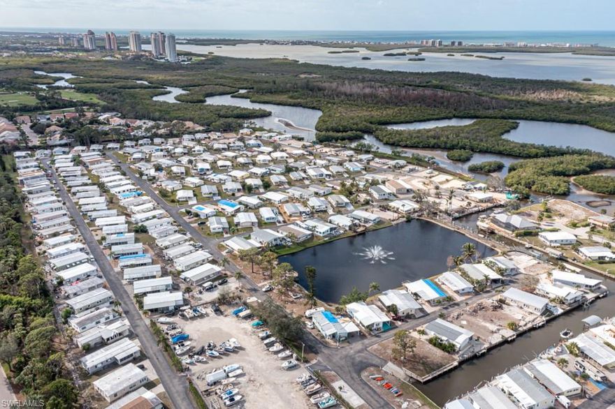 Dock your boat at this waterfront lot on owned land with a  paver patio area along the canal  and 2 paver stairways. By  boat Estero Bay is 6 min away with your toes in the sand on the beach, shelling, watching dolphins, manatees or fishing then eating out at any of the many waterfront restaurants. And only 12 minutes to the Gulf of Mexico  to watch the tropical sunsets via New Pass and more beaches of Lovers Key State Park.  The vacant lot is waiting your dream home. New homes can be built on site with concrete columns and parking underneath. Or a manufactured home.  The Lots are owned and the HOA fees are low at $246.00 per quarter. Spring Creek Village is an amenity rich community with clubhouse, planned activities, pool, hot tub, shuffleboard, tennis, pickle ball, bocce ball, basketball, picnic area, lake w/ fishing pier, free kayaks use, boat ramp, boat storage compound, etc. Low fees, great location, min to Coconut Point Mall, Lee Health at Coconut Point, Hertz Sports Arena, Lee County Sports Complex, SWFL international Airport, Florida Gulf Coast University,  shopping & public  golf courses