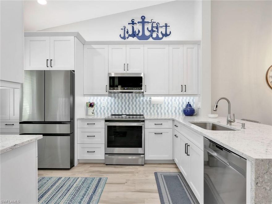 Located in the gated community of Huntington Lakes in Naples, Florida, this updated three bedroom, two bathroom condo offers a spacious layout, quality improvements, a peaceful lake view, and access to a wide range of amenities in one of North Naples’ established neighborhoods. This residence features new ceramic tile installed in 2023 in the Great Room, Dining Room, and Kitchen and new luxury vinyl plank flooring in the bedrooms, creating a clean and cohesive look from room to room. Natural light fills the interior, enhancing the open concept design and highlighting the updates completed over the past several years. Large windows and the enclosed lanai frame tranquil lake views, bringing a sense of openness and connection to the surrounding landscape. The kitchen was remodeled in 2023 and showcases modern finishes and functionality. A striking waterfall countertop edge adds a distinctive design element while maintaining a practical workspace. Updated New cabinetry and  flooring, creating a fresh and polished feel. The layout flows seamlessly into the main living area, allowing for comfortable everyday living. Both bathrooms were fully remodeled in 2022 with contemporary finishes and fixtures. Clean lines and updated materials provide a refined look while offering durability and comfort. The primary suite includes an en suite bath and generous closet space, while the additional bedrooms provide flexibility for residents or guests. Significant mechanical and structural updates provide added value and peace of mind. The building received a new roof and hurricane impact windows in 2021. The unit is also equipped with a new air conditioning system installed in 2021 and a new hot water tank added in 2023. In 2025, acrylic accordion style sliding windows were added to enclose the lanai, allowing for year round enjoyment while maintaining the option to open the space and welcome in the breeze when desired. The enclosed lanai enhances the overall living area and offers a comfortable vantage point to enjoy the lake view in every season. Combined with the abundant natural light throughout the unit, the space feels bright and inviting while taking full advantage of the waterfront setting. Residents of Huntington Lakes enjoy a gated entrance and an amenity rich environment designed to complement the Southwest Florida lifestyle. The community features a clubhouse, fitness center, 3 resort style swimming pool, spa, tennis courts, and walking paths set among mature landscaping and scenic lakes. Social activities and gathering spaces provide opportunities to connect with neighbors and enjoy an active calendar of events. Another notable benefit is the comprehensive HOA fee, which includes water, sewer, internet, and cable television. Huntington Lakes is ideally positioned in North Naples with close proximity to shopping, dining, medical facilities, and Gulf beaches