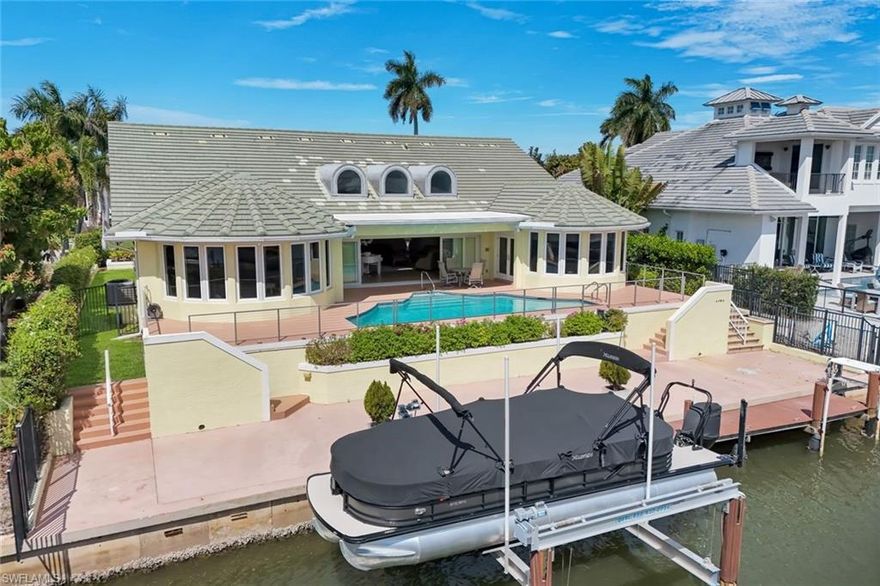Experience the pinnacle of Naples waterfront living in this exceptional custom-built residence, ideally positioned just moments from open water on Naples Bay with direct Gulf access. Located in Royal Harbor—one of only a few true waterfront neighborhoods in Naples—**this high-elevation home offers peace of mind with impact windows and doors throughout and an unbeatable boating lifestyle. Boasting just under 3,800 square feet of living space, this light-filled home showcases soaring ceilings and an expansive open floor plan designed for both elegant entertaining and relaxed coastal living. The Gourmet Kitchen has Sub-zero refrigerator, double built-in convection ovens, induction stovetop with hidden downdraft. This home Features 3 spacious bedrooms plus light filled Den and 3 full baths, the primary suite is a private retreat with dual his-and-her bathrooms and generous walk-in closets. Boaters will appreciate the newer boat lift and fish cleaning station. Prime location just a few homes from open water—bring your boat and enjoy all the Gulf has to offer. Additional highlights include a newer AC system, enhancing comfort and efficiency. Step outside to your beautiful, heated pool and enjoy tranquil waterfront views while watching dolphins frolicking by. Oversized 2 car garage with large circular driveway. Just a few minutes to Downtown Naples and all the best shopping and dining. This home truly captures the essence of luxury coastal living. A rare opportunity in one of Naples’ most desirable waterfront communities with HOA at only $75 a year!