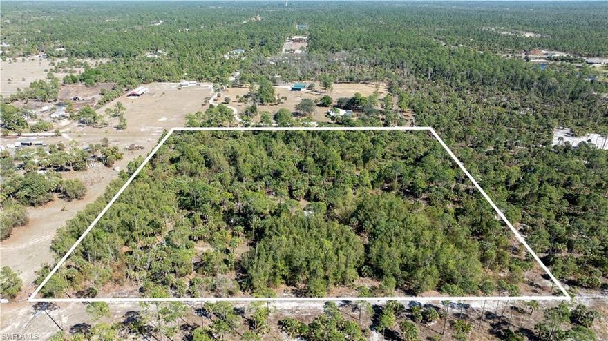 Located at 630 Pioneer Trail, this exceptional 10-acre square parcel presents a rare opportunity in a rapidly growing area of Naples. The property consists of 100% buildable uplands and offers both residential and agricultural zoning, providing flexibility for a variety of uses.
Investors will recognize the subdivision potential of this well-proportioned lot, with key infrastructure already in place, including 200-amp electrical service, new power poles and transformer, recently installed cable lines, a deep freshwater well, family-sized septic system, and paid impact fees — significantly reducing upfront development costs.
For those envisioning a private estate or family compound, the land is partially cleared with established perimeter and cross-fencing. A manufactured home is currently on site, and the property features quality soil conditions with superior perc sand, limestone base, and rock-free composition to approximately eight feet.
The agricultural zoning also creates immediate potential for business use, including landscaping operations, nursery development, or other agricultural ventures. Existing structures, strong electrical capacity, and the versatile layout allow for operational efficiency from day one.
Whether for investment, development, agricultural use, or a private estate, this is a compelling 10-acre offering in one of Naples’ most dynamic growth corridors.