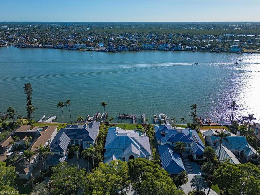 Rarely available Bayfront home in Aqualane Shores! Sweeping vistas across Naples Bay invite you as you enter this 2022 exceptionally renovated home. Incredible floorpan with 4 bedrooms on the main living level and two bedrooms on the 2nd level, one of which is a second primary suite capturing unparalleled views down Naples Bay towards Gordon Pass. Sitting at 1.7' above FEMA's current flood, new roof in 2020, impact resistant windows, New dock, storm shutters, wide plank white oak Legno Bastone wood floors, beautiful Allikriste kitchen cabinets and bar area, Clive Daniel furnishings, and an updated pool deck/pool are just a few improvements made to this spectacular residence. Experience the best of everything Downtown Naples offers as you have walkability to the beach and 3rd st. restaurants, unrivaled views, and direct bridge free access to the Gulf of Mexico. Truly a unique location in the heart of Downtown!