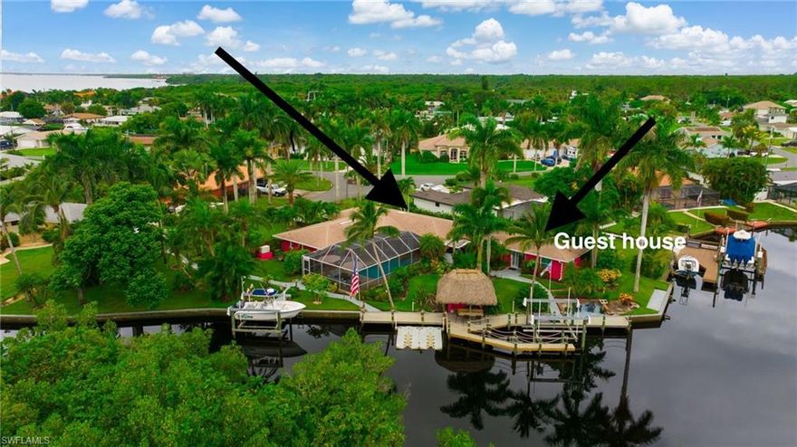 New Price reduction! Gulf Access. Multigenerational or Mother in Law unit.  This home offers Two separate living areas!  You have to see it to believe it!  Prepare to be AMAZED! What appears modest from the front, opens to a stunning, unexpectedly spacious and beautifully designed home inside and the back will leave you speechless!  Income potential! Live in one and rent the other, or use as a guest home. A rare waterfront gem in coveted Yacht Club Colony where lifestyle, luxury, and income potential all come together. The main residence offers 4 bedrooms, 3 baths, and a chef’s kitchen with abundant storage and pantry, while the fully private guest home includes 1 bedroom, living room, dining, galley kitchen, full bath, and laundry, separate parking area and entry—ideal for in-laws, Airbnb, Guests, or event rentals. Both homes are newly and fully updated. No access into the guest house from the main living area make it completely private.  Beautiful Plantation shutters throughout!  
Step outside to your tropical oasis with a sparkling saltwater pool and screened lanai, a 12x16 tiki hut ready for entertaining, and winding garden paths through lush landscaping. A true fruit lover’s paradise, the property boasts mango trees, coconut, guava, lime, orange, avocado, banana, papaya, starfruit, passion fruit, dragon fruit, macadamia, and even five thriving monstera deliciosa—harvest fresh fruit year-round! Privacy abounds with no visible neighbors, just nature and tranquility.

Upgrades include a whole-house generator with 500-gallon propane tank, 48” custom flood-barrier system, ADT security in both homes.
This home boasts brand-new appliances, two new water heaters, updated ductwork and insulation, RV/EV hookups, and RV blackwater drain, welder circuit, and more. The 250’ concrete bulkhead in excellent condition, and the synthetic no-rot decking and wood pylons are one yr old which hosts two amazing boat lifts (16,000 & 11,000 lbs). along with the EZ Dock jet ski ramp for two watercraft. There is both electric and water at the dock. 
This home sits on direct access on a deepwater canal—just a few minutes to open water with no bridges. Explore mangrove-lined waterways, watch dolphin and manatee, beautiful birds, and enjoy Florida wildlife right from your backyard. Minutes from Cape Coral by water or land.
Perfectly located minutes from downtown Fort Myers and I-75, with convenient access to two nearby airports, this home blends privacy with accessibility.  Waterfront restaurants and popular boating destinations are only a short boat ride away. Access to both sides of the Ocean, plus waterfront restaurants just a quick boat ride away. Don’t miss your chance to own one of Yacht Club Colony's  most extraordinary private deepwater canal-front properties—a rare blend of elegance, function, and true Florida lifestyle. If you're looking to step right into your new home, without worry, this is the one. Furniture and Boat negotiable.