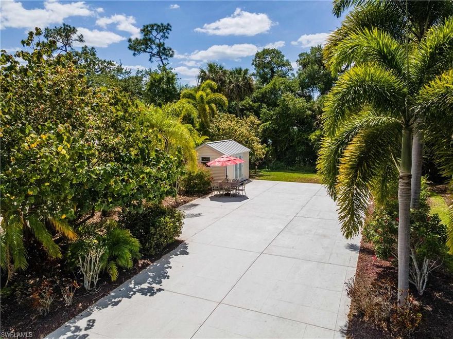 Resort-Style Living on the Caloosahatchee River! Lot 294 is a charming back-in lot that overlooks a spacious, grassy common area, offering shade from the late afternoon sun and a peaceful, picturesque setting. The concrete pad is in excellent condition and is paired with a beautifully finished 10’x14’ coach house including a kitchen sink, cupboards and bathroom. Surrounded by mature landscaping, this lot creates a private backyard space that is ideal for pets or simply relaxing. Included with the sale is an off-white outdoor table with matching chairs and umbrella, perfect for enjoying the serene atmosphere. and the potential to be transformed into a charming 16’x26’ coach house.  When you’re ready to explore, RiverBend offers a wide variety of luxurious amenities that combine relaxation and fun all in one place. With a prime location on the Caloosahatchee River, enjoy stunning views and a variety of activities to keep you entertained. Take a dip year-round in the large heated pool, or unwind and relax in one of the two hot tubs. Enjoy drinks by the pool bar while soaking up the sun, and when you’re ready for more, head to the pool clubhouse for a game of ping pong, cards, or work out in the exercise room. For some friendly competition, challenge your neighbors to a game of bocce or shuffleboard, or practice your swing on the beautiful putting green. Enjoy a variety of card games, or have fun with remote control cars and boats. The River Clubhouse offers even more entertainment with a full-service bar, billiards, dancing, bingo, and bunco nights. On Saturday mornings, watch the model trains chug along the tracks, crossing over bridges and weaving through tunnels. As they pass through miniature villages, the tiny homes and detailed structures add a charming touch to the scenery. Relax and take in the peaceful surroundings from the gazebo, or enjoy easy access to the boat dock, perfect for your adventures on the river. Convenient trailer and boat storage facilities are available, ensuring you always have space for your gear. Unleash your creativity at the Creations Clubhouse with arts and crafts. This property truly has it all for those seeking an active, vibrant lifestyle. Come see what makes this community so special and start living the life you’ve always dreamed of.