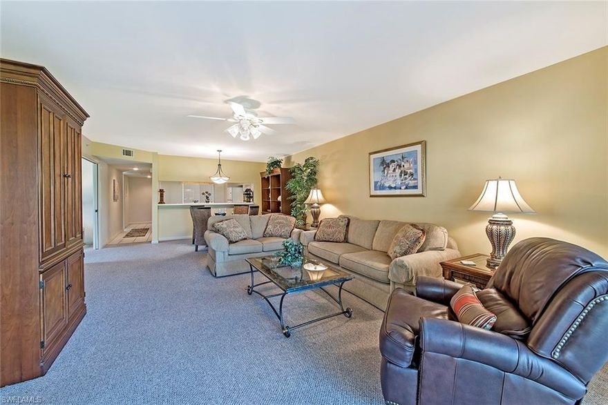 Look no further -- Best value for an affordable dream life!  Move in with nice furnishings in this spacious 3 Bedroom, END unit. Enjoy no-steps, 1st Floor ease, extra windows, unique big back yard space.  Gaze at amazing panoramic Golf and Lake views, preserve across, from your private screened lanai.  Bonus of new golf course with assessment PAID by seller!  Plus just step out your door to Pool, Hot tub, Tennis, Pickle ball, shuffleboard, and neighbor socials.  Unique Entry Foyer, sunny Side windows, extra windows in both bedrooms.  Private  lanai door exits to a big lawn -- great if you have a small dog.  Assigned covered parking conveniently right at your door & ample guest parking.  Head to Clubhouse for Dining, Bar, Billiards, Ping pong, Library, Art, Card rooms, Fire pit & so much more!  New Fitness center, classes all included, Bocci ball, grab breakfast or lunch at the Divot.  FULL Golf membership included too. Plus LOCATION!  All conveniences out front & back gates. Only 4 miles to downtown Olde Naples, beaches, dining, shops, art, theatre and more! Near I-75. Perfect Full or Part time. Superb Rent can cover costs, use other times. Newly painted.