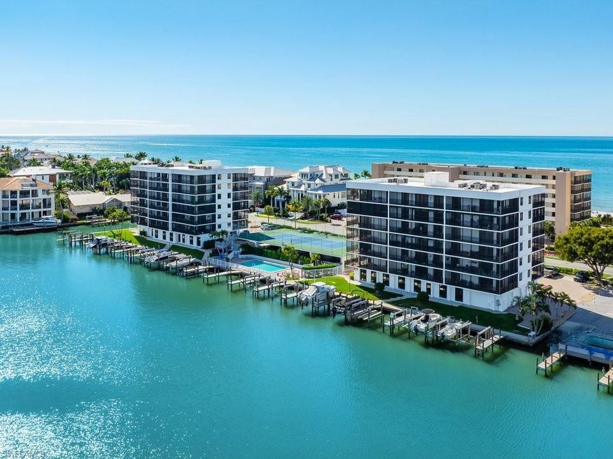 Welcome to this stunning updated 2-bedroom, 2-bath, end unit condominium which features sunrise Vanderbilt Bay vistas and sunsets over the gulf from the generous screened balconies that face both East and West. Boasting an open concept living area of 1329 sq ft, plus more than 400 additional square feet of wrap-around covered and screened balcony space.  You will delight in spectacular views and ocean breezes from almost every room.  The sun and sand of Vanderbilt Beach are just steps away with deeded private beach access.  Unit renovations include updated kitchen and baths, tile and vinyl plank flooring throughout, granite countertops, plantation shutters, walk-in closet, tray ceilings and crown molding.  Owners can enjoy the Naples sunshine at the community pool and tennis/pickleball court overlooking the bay, outdoor shower and grill area.  The condominium property has a liberal rental policy which allows for a minimum 30-day rental period twelve times a year.    A wide selection of dining and shopping options are just minutes away, bike or stroll along the beach, or retreat into the quiet privacy that is Vanderbilt Beach. This is not just a residence, but a Naples beach lifestyle opportunity.