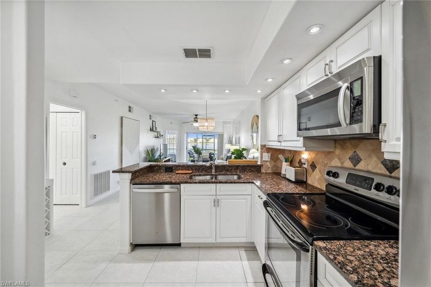 Step into effortless Florida living with this beautifully maintained, TURNKEY first-floor 2-bedroom, 2-bathroom unit in the sought-after Cavendish Court at Worthington. Offering 1,076 square feet of thoughtfully designed space, this home delivers the perfect combination of comfort, convenience, and coastal elegance, and it's completely move-in ready.

From the moment you enter, you'll appreciate the open floor plan and screened entry, ideal for embracing the indoor-outdoor lifestyle. The gourmet kitchen is a standout feature, boasting stainless steel appliances, a brand-new dishwasher, upgraded countertops, and a stylish backsplash. With a seamless connection to the living and dining areas, it's perfect for hosting guests or enjoying quiet evenings at home.

Throughout the home, tile flooring and ceiling fans provide a cool, low-maintenance environment. The entire unit has been freshly painted, giving it a crisp, like-new feel. The spacious primary bedroom offers a true retreat, with sliding doors that open to a screened-in lanai overlooking the 3rd hole of the championship golf course, a serene pond with a picturesque fountain, and breathtaking sunset views. The en-suite bathroom is designed for relaxation, featuring a walk-in shower, vanity area, and generous walk-in closet.

A well-appointed second bedroom and full bathroom provide excellent flexibility, ideal for guests or a dedicated home office. Additional highlights include in-residence laundry with a brand-new washer, a dedicated one-car carport, and fresh interior paint throughout, ensuring a truly turnkey experience from day one.

Beyond the home itself, Worthington delivers an enviable resort-style lifestyle within its gated community. Residents enjoy access to bocce and tennis courts, a championship golf course, clubhouse, fitness center, community pool and spa, an on-site restaurant, and more, all designed for relaxation and recreation.

Situated just off Bonita Beach Road, this prime location offers quick access to premier shopping, dining, and entertainment options, placing everything you need within easy reach. Don't miss your chance to own this turnkey gem in one of Southwest Florida's most desirable communities. Schedule your showing today!