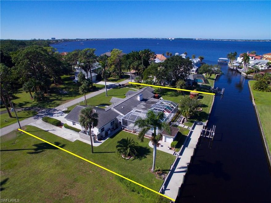 This is a great opportunity to own a home on the water with a HUGE yard that is well built that SITS ON 2 LOTS on a direct access intersecting canal—200ft of seawall frontage with lift, only 2 lots from the river. Beautiful property, only 1 owner, with approximately 2700 sq. ft. of living area, with pool, tile roof, oversized rooms, eat-in kitchen, island, living room with  fireplace, master bedroom, 2 closets, oversized bath with tub and shower, office, formal dining, plenty of storage, inside laundry, workshop, and additional driveway. Location and Value on the riverside of McGregor in the Whiskey Creek Subdivision!