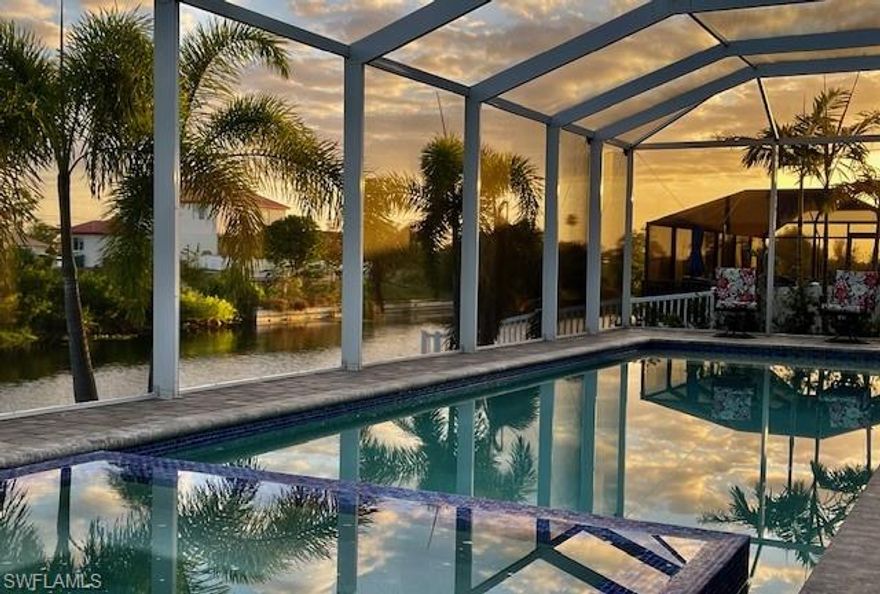Stunning custom built southern exposure waterfront pool home completed in 2022, offering modern design, quality finishes, and approximately $96,000 in upgrades completed in 2025–2026. This 3 bedroom, 2 bath residence features an open great room floor plan, impact resistant windows and doors, and seamless indoor-outdoor living. The spacious gourmet kitchen is the centerpiece of the home, showcasing quartz countertops, a waterfall island, LG Signature induction cooktop, LG Studio wall oven and speed oven, LG Studio range hood, Bosch dishwasher, custom cabinetry, and kitchen reverse osmosis water purification. The bright main living area opens through impact sliders to the screened lanai, creating an ideal setting for entertaining and everyday Florida living.
Step outside to your own private waterfront retreat featuring a heated saltwater pool and spa, expansive screened lanai, freshly cleaned, sanded, and sealed pavers, and beautifully enhanced tropical landscaping with newly installed palm trees and garden plantings. The privacy fenced yard creates a rare sense of seclusion and security, offering an ideal space for pets, outdoor enjoyment, and peaceful relaxation while still taking full advantage of the waterfront setting. Added irrigation and drainage systems, along with pool overflow and water softener drain line improvements, make the exterior as functional as it is attractive. Freshwater canal views and a seawall complete the outdoor appeal.
Inside, this smartly upgraded home includes Sonos speakers in 3 zones, wiring for 5.1 surround sound in the living room, custom lighting, whole-house 2-inch custom blinds, monitored alarm protection for all windows and doors, security cameras, HVAC soft start with UV air purification, and a whole-house generator with a 100-gallon propane tank. Smart home app access integrates the alarm system, lighting, Sonos, Rainbird irrigation, Pentair pool controls, lanai Wi-Fi, and kitchen and laundry appliances for added convenience and peace of mind. The laundry room is equipped with a washer, dryer, laundry sink and offers abundant cabinet space for storage. Fresh paint in the bedrooms, baths, and at the front door adds to the move-in-ready appeal.
Set on a freshwater canal lot with no HOA fees, this exceptional property blends modern comfort, thoughtful upgrades, privacy, and waterfront lifestyle in one beautifully maintained Cape Coral home.