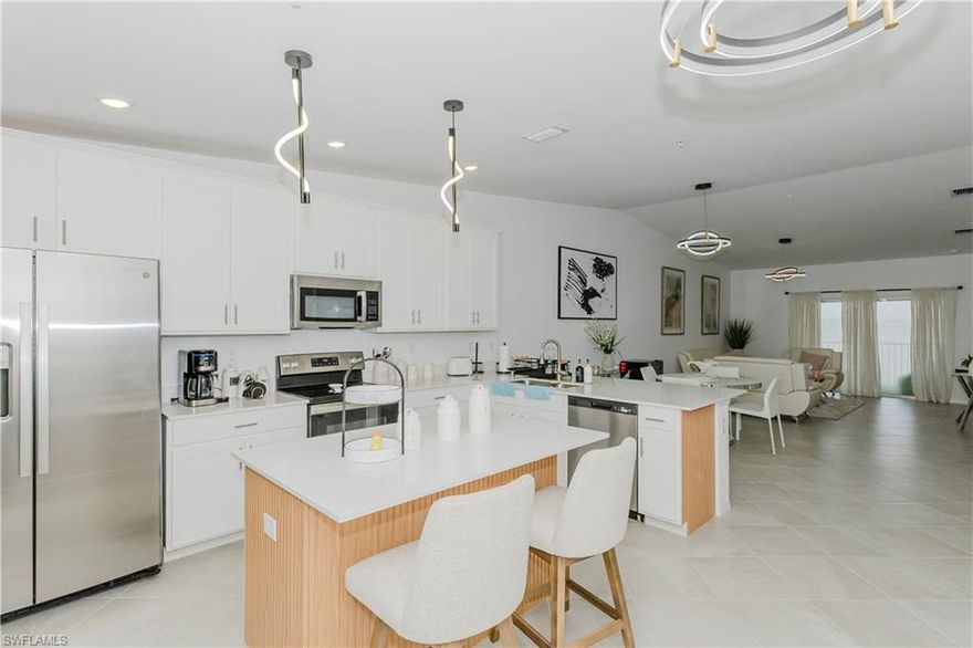 This like-new Bromelia model offers a perfect combination of privacy, comfort, and resort-style living. With two split bedrooms, two full bathrooms, and a spacious den, the layout is ideal for full-time residents seeking a relaxing retreat. The open-concept living area is enhanced by high-volume ceilings and abundant natural light, while the modern kitchen is fully equipped and perfect for entertaining. The den includes a full-size TV and comfortable seating, making it ideal as a home office or extra lounge area. Step outside to a screened-in lanai and enjoy a west-facing view of the lake and golf course, providing stunning sunsets that create the perfect backdrop for evening relaxation. The condo's prime location is just a short walk to the community pool, tiki bar, fitness center, and golf pro shop. Located in the highly desirable community of Ave Maria, currently ranked as the 16th fastest-selling community in the U.S., this home offers a true resort lifestyle in a welcoming and vibrant setting. Ave Maria—once you get here, you “get it.” THIS UNIT DOES NOT COME WITH GOLF