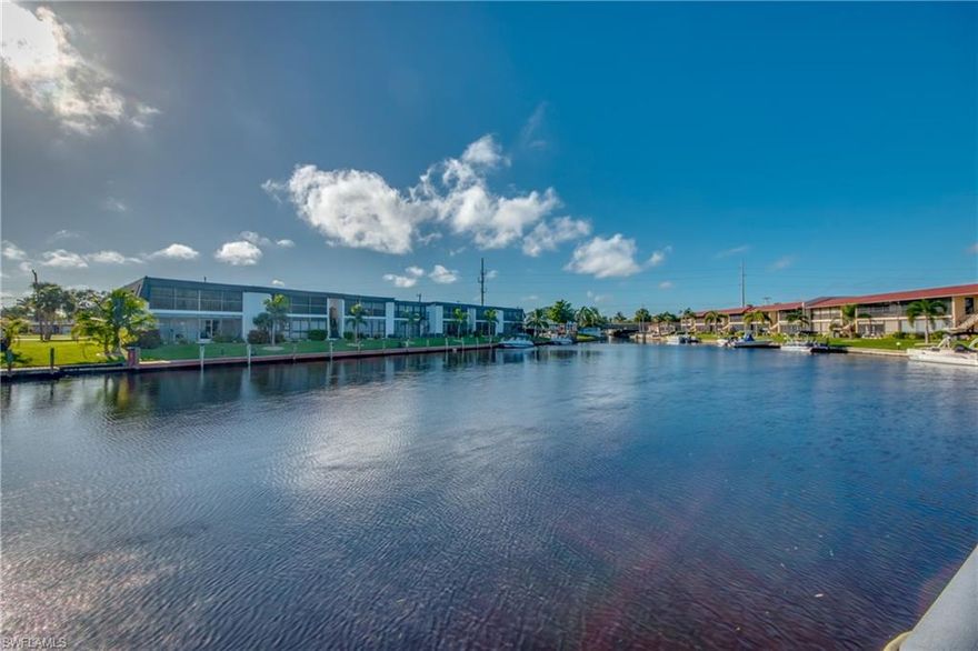 Gulf Access, 2nd Floor Condo with a beautiful canal view located close to shopping and downtown Cape Coral. The roomy kitchen has lots of counter space, and both baths have been remodeled.  The master bedroom and the living area has sliders out to the screened balcony where you can sit and sip your morning coffee; and watch the boats go by.  The second bedroom can be an office and a bedroom with the hidden Murphy Bed.  You can dock your boat.....first come first serve.  This condo complex was just updated with a new roof, gutters including the facia, and carport.   This is a nice 55+ complex nestled on a quiet street.  This unit may be turnkey or furnishings negotiable.  Motivated seller -- bring all offers!
