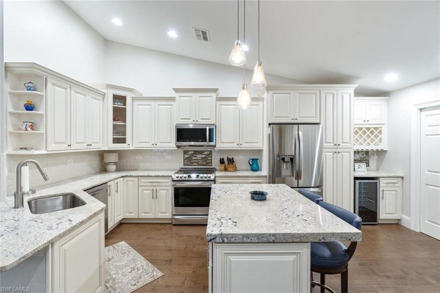Offered turnkey! Exquisitely renovated & professionally designed & furnished, this Villa lives like a single-family home with all the bells & whistles! Every inch of this home has been updated. The large kitchen opens up to the living area & features new cabinetry, granite counter tops, center island with breakfast bar, stainless steel appliances, modern backsplash, separate bar area with wine refrigerator, wine storage & formal dining room. The updated Master suite offers a backlit mirrors, dual vanities & seamless glass walk-in shower. The guest accommodations have also been beautifully updated. Enjoy the peaceful & private view through the sliders from the updated or enjoy a cup of coffee or adult beverage on the screened, covered lanai. All the modern features you want – luxury, neutral finishes & furnishings, plank-style flooring, designer lighting, volume ceilings, plantation shutters, new paint – plus a garage! Located West of 41 in Fountain Lakes, with LOW HOA fees & great amenities with 9 hole executive golf course, Clubhouse, pool, billiards, tennis/pickle ball, gym & more. Across the street from Coconut Point w/dining, shopping & entertainment. This won’t last long!