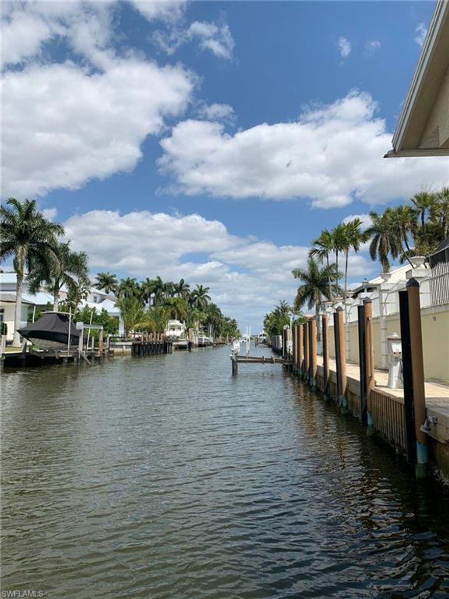 3 1/2 blocks to the beach.  2 blocks to 3rd Street South.  Boaters dream home with 2 boat lifts and +/- 92 feet of seawall mooring space on an oversized lot.  Direct gulf access. One of the two boat lifts is a covered boat house with adjacent air conditioned garage with full bathroom and shower.  Storage space galore in this home.  Total of 4 garage space.  Master site with a total of 3 bedrooms a den, 4 full bathrooms and 1 half bath.  Ability to add a 4th bedroom to make this home 4 full bedrooms and a den. Tall ceilings throughout. Raised elevation. Propane generator.