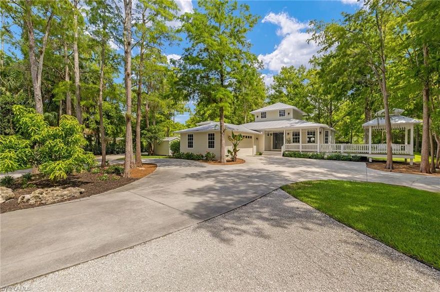 A Private Paradise in Logan Woods – Luxury, Privacy, and Nature Combined. Discover one of Naples’ most extraordinary estates, tucked away in the coveted community of Logan Woods. Set on 2.87 fully fenced acres, this fully renovated farmhouse retreat offers the ultimate in seclusion, luxury, and outdoor living—just six miles from the Gulf Coast’s pristine beaches and world-class shopping and dining at Mercato. The main residence spans 2,871 square feet. Just a few steps away from your backdoors, a gorgeous pool house includes an additional 1,000 square feet of versatile space, perfect for a home office, studio, recreation space, or "man cave". Over the past three years, the property has been thoughtfully updated with countless upgrades, including a brand-new A/C unit (2025), new hardwood flooring throughout (2022), a new washer and dryer (2023), and a completely new septic drainfield (2023). A gravel drive leads to a designated boat and RV parking area, offering both convenience and functionality. Step outside and experience a breathtaking, park-like backyard that feels like your own private resort. Mature, meticulously curated landscaping—featuring lush sod, dense clusia hedges, and towering fishtail palms—creates unmatched privacy. Enjoy the security of a new solar-powered gate (2023), and relax knowing your grounds are maintained for only $350 per month. A smart irrigation system, powered by your private well, makes care effortless. At night, professionally installed landscape lighting transforms the property into a magical escape. The centerpiece of the backyard is a stunning new outdoor fireplace framed by stone pavers and pathways, offering the perfect setting for gatherings or quiet evenings under the stars. Inside, you’ll find four spacious bedrooms and two beautifully appointed bathrooms, blending modern comforts with timeless style. The separate shared living spaces allow for plenty of flexibility within the floor plan. Enjoy peace of mind with the structurally sound stem-wall construction giving the home elevation and solid foundation. Located within one of Collier County’s top-rated school districts, including Vineyards Elementary, Oakridge Middle, and Barron Collier High, this estate is the perfect blend of daily living and private luxury. This is more than a home—it’s a rare opportunity to own one of the most spectacularly landscaped and thoughtfully updated properties in all of Naples.