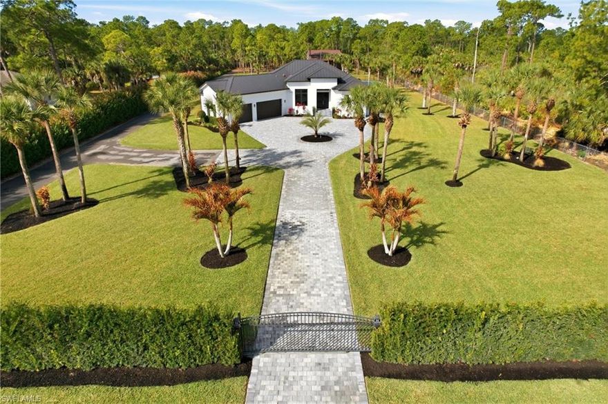 Welcome Home!!  This inviting home in Naples is on 2.73-acres of uplands, where wide open space meets sunshine, serenity and endless possibilities. Luxury living meets unparalleled recreation. This meticulously maintained estate offers the perfect blend of sophisticated design and "staycation" amenities, making it the crown jewel. Step inside this spacious 3-bedroom plus den, 3-bathroom masterpiece. The open-concept floor plan is flooded with natural light, featuring high trayed ceilings. The dedicated den provides the ideal space for a quiet home office or a cozy media room. The heart of the home is a gourmet kitchen that flows seamlessly into the living area and dining area, perfect for hosting grand gatherings or intimate family dinners.
The outdoor oasis has doors leading to the pool area to discover your private paradise. The expansive screened lanai houses a sparkling pool with jacuzzi, ideal for cooling off under the Florida sun. Beyond the pool area, the property truly comes alive. Sports enthusiasts will fall in love with the fenced pickleball/basketball court, offering endless hours of competitive fun right in your backyard.
The Massive detached garage/workspace in the backyard is for the car collector, hobbyist, or business owner, this property is a dream come true. Whether you need space for a boat, an RV, a classic car collection, or a specialized trade workshop, this building offers the scale and versatility you've been searching for.
With 2.73 acres of lush, sprawling land, you have the rare luxury of space and privacy. Which is fully fenced with 2 automatic gates and 2  right of way entrances. Whether you want to expand the gardens, add a guest house, or simply enjoy the peace of your own gated perimeter, this acreage provides a canvas for your imagination. In addition to all this, you have your own area for target practice/with berm
No HOA Restrictions – Bring your toys, trucks, and RVs. One of the only streets with a sidewalk. Fire Station and library within 1 mile distance from home.
Experience the freedom of acreage without sacrificing the luxuries of a modern estate. Perfect winter retreat, Airbnb investment or private residence. Schedule your private tour today and see why this is the most versatile property on the market!**Home is being sold Turnkey/Furnishings included!!