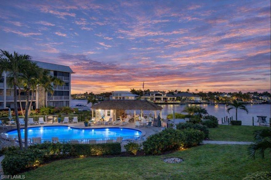 Experience the ultimate Naples waterfront lifestyle in this beautifully updated boating residence, perfectly positioned on Doctors Bay in the highly desirable Moorings. This is a property that truly needs to be seen in person to fully appreciate the quality, setting, and lifestyle it offers. Renovated waterfront units in this location are rarely available, and opportunities like this do not come along often. With the Gulf’s sugar-sand beaches just across the street and boat docks available for lease, this home delivers a unique blend of beachside and bayfront living. Conveniently accessed via elevator from your covered parking space, this second-floor 2-bedroom, 2-bath residence features an open, airy layout designed for relaxed coastal living. Floor-to-ceiling impact-resistant sliders frame tranquil water views and flood the home with natural light, creating a seamless connection between indoor comfort and the surrounding waterfront scenery. The interior has been completely reimagined with tasteful, modern upgrades throughout. Highlights include large-format tile flooring, crown molding in the main living areas, and thoughtfully designed custom built-ins in both the dining space and primary suite—offering added storage rarely found in comparable units. The kitchen is a true showpiece, appointed with quartzite countertops, stainless steel appliances, and a self-cleaning steam double oven, making it ideal for entertaining or everyday enjoyment. Both bathrooms have been fully renovated with refined finishes that complement the home’s coastal aesthetic. Step out onto your private balcony to enjoy gentle bay breezes and a glimpse of the Gulf beyond, or relax at the community pool and recreation area overlooking Doctors Bay—an ideal vantage point to watch passing boats and take in colorful Southwest Florida sunrises. Additional conveniences include a designated carport space and a well-maintained community poised for upcoming enhancements such as fresh exterior paint, new railings, updated lighting, gutters, and walkways. Set within one of Naples’ most coveted waterfront neighborhoods, this residence offers effortless access to world-class boating, pristine beaches, fine dining, and upscale shopping. Buyers seeking a move-in-ready waterfront property in the Moorings are encouraged to act quickly, as renovated Bayfront residences with immediate beach access are seldom offered. Whether cruising the waterways, walking the beach, or simply enjoying the peaceful bayfront setting, this is coastal living at its finest—where the Bay and the Gulf come together.