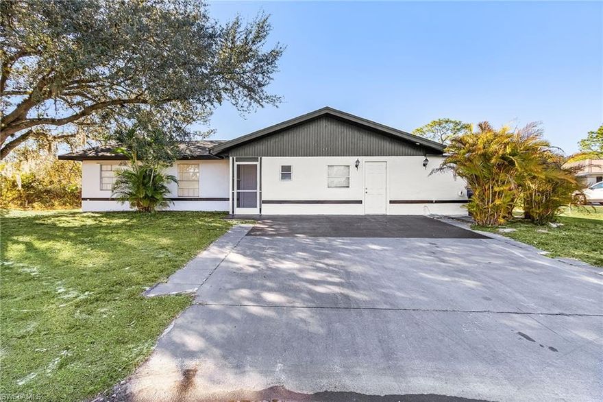 Centrally located in Lehigh Acres, this well-maintained wood-frame home offers 1,750 sq ft of comfortable living space on a spacious half-acre lot. Recently painted inside and out, the home features new light and plumbing fixtures, tile flooring throughout, and stainless steel appliances in the kitchen. The large master bedroom includes an oversized closet, providing a private retreat. A brand-new roof completed in December 2025 adds peace of mind. With plenty of room for a pool, outdoor entertaining, and family gatherings, this property offers space, updates, and a convenient location—perfect for enjoying Florida living at its best.