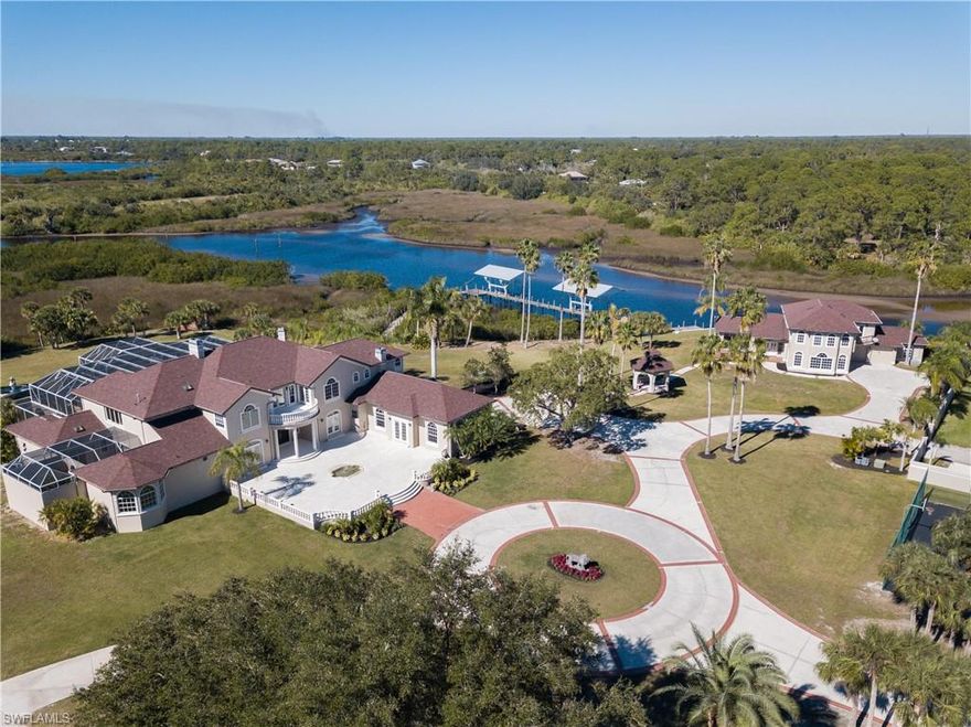 Serene, Graceful Waterfront Living Awaits in this Expansive Estate Situated on 14+ Acres. This Estate Features Gated Entrance w/ 2 Additional Gated Points of Entry. A Private Drive leads to the Main House presenting over 8,000sq. feet of Living Space w/ 5 Bedrooms-all w/ en-suite Baths, Two 1/2 Baths & 4+Car Garage. Main Level Includes Volume Ceilings, Crown Molding, French Doors, Tray Ceilings, Grand Foyer, Formal Living Room w/Fireplace, Formal Dining Room, Impressive Spacious Kitchen w/Fireplace & Handsome Executive Office. Master Suite offers His & Her Master Baths, Private Patio, Loft w/Private Staircase & Magnificent Views of the Waterfront & Pool Area. Large Screened Lanai & Pool Area are Ideal for Entertaining. 2nd Floor Features 3 Guest Bedrooms, Open Loft w/Wet Bar & Balcony. Circle Drive leads to the 2 Story Guest House w/attached Garage, offering Spacious Entertainment Area & then Upstairs 2 Bedrooms, 1 Bath, Den/Office & Balcony overlooking the Waterfront. 2 Covered Boat Docks w/Lifts & just Moments to Beautiful Myakka River & onto Charlotte Harbor. In Addition to the Views, this Exceptional Estate offers Privacy, tennis court & Additional room to Build. Must see!