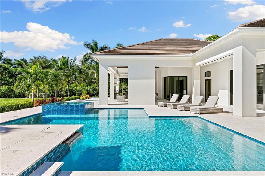 This beautiful contemporary, open-concept home was built in 2021 and sits on a quiet street in Pine Ridge Estate on 1.19 acres. The Stock Custom, single-story home, is just under 5,000 square feet and features four bedrooms with en suites plus a bonus room and study, as well as a chef’s kitchen, butler’s pantry and an enclosed glass wine room. The expansive outdoor area faces southwest and is ideal for entertaining with additional summer kitchen and bar, and multiple lounge areas that overlook the pool and spa. The residence is complete with a double two-car garage and is conveniently just a short distance to Waterside Shops, Mercato and white-sand beaches.