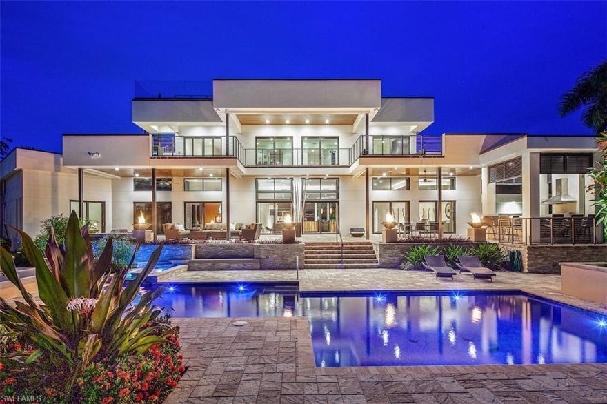 H.14829 Luxurious. Elegant. Exceptional.  European style & design blend together beautifully in this Southwest facing waterfront tropical estate on a nearly half ac. lot w/ 164’ of water frontage & Gulf access. Clean contemporary lines & luxurious finishes are accented by walls of glass & gorgeous views.  Featuring an open floor plan w/ sleek kitchen & unique finishes such as Brazilian rosewood, linear eco-friendly fire feature, & custom steel & glass floating stairs & walnut flooring.  Zen-like master suite w/ sitting room & dressing room, plus indoor/outdoor garden shower & Japanese Aioki wood soaking tub.  An addtl. ground floor guest suite allows flexible accommodation. Upstairs living room w/ wet bar & 4 more bedrooms all with SW water views, & spacious balcony.  There’s also a rooftop viewing balcony w/ Gulf views.  Stunning outdoor area that rivals any 5 star resort, & includes a pool w/ cascading water feature, spa, terraced verandas & outdoor kitchen pavilion.  A water enthusiasts dream, with 80’ dock, 2 separate boat lifts, plus jet ski lift. Live the ultimate tropical lifestyle, surrounded by flowering trees & swaying palms steps to the beach & downtown Naples.