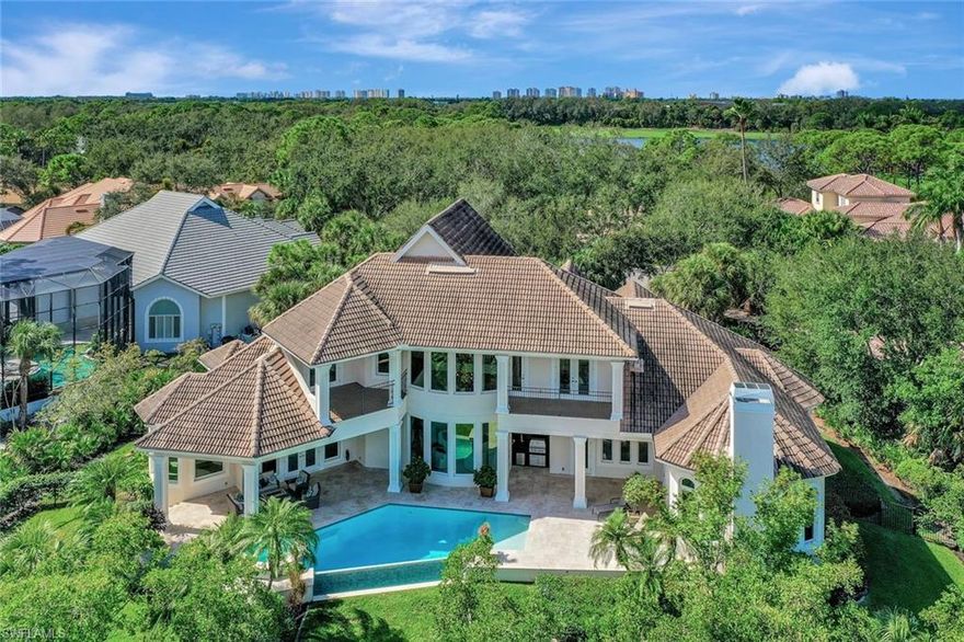 H12004. Architectural Showstopper in Audubon Sanctuary! Tucked away off a quiet cul-de-sac, this French Country-style Manor is the perfect escape from the ordinary. Affording the privacy of a 27,000 SF (0.62 acre) site, the residence was commissioned for a 4-BR+Den plan complemented by expansive outdoors w/ 226 ft. nestling against a nature preserve. The open-concept interior is flooded with natural light showcasing remarkable architectural elements, from walls of tall nature-reflecting windows to soaring ceilings w/ exquisite coffered & tray ceiling detail. Luxury amenities include a 500-bottle climate-controlled wine room; butler's pantry; gas fireplace; and wood-paneled elevator to the upper-level. The fabulous owner's suite w/ French doors to the lanai features a light-filled retreat, two XL walk-in wardrobes and a gorgeous marble bath. A chef's delight is the island kitchen incl. gas cooktop, double wall ovens, a walk-in pantry & ample granite-topped custom cabinetry. The renovated negative-edge pool, spa, stone deck & poolside BBQ are pure pleasure to share. An over-sized 2car+golf cart garage, impact windows/doors and a soon-to-be-installed new flat tile roof top it all off.