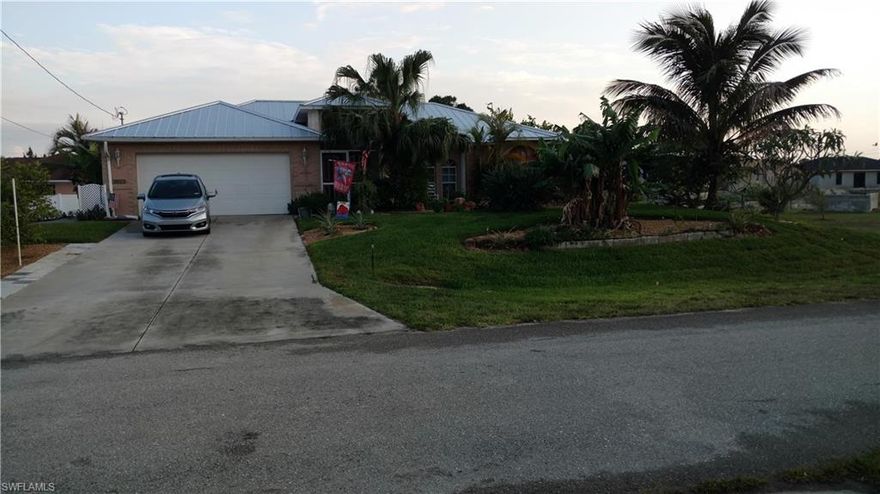 3/2/2 pool tropical home. Pool cage over heated pool plus hot tub built into a rock mountain with waterfall. Oversized master suite has two walk-in closets. Tiled master bath plus linen closet/toilet room. One bedroom was office/studio complete with built-in cabinets & Murphy bed. All rooms have 18” tile plus tile baseboards. Main rooms are painted white. Guest bathroom has tile. Kitchen and breakfast bar have marble countertops and kick side of bar. Large pantry. Appliances remain. Front cathedral curved windows. Screened entrance tiled. Laundry room has front load appliances and sink. Garage built in cabinets, garage door opener. Enjoy front pond with two waterfalls and bench. 30 edible types of fruit bearing trees/plants on 1/2-acre. Walk under a grape vine arch to sitting area with pond and waterfall. Raised containers for garden complete with shade cloth. Car hauler remains plus another small storage shed. In the grove, 400 square foot raised garden. Approximately $40,000 of tile work both inside and out plus rock structures. 2017 metal roof. RV parking and 50 amp electric/water. $15,000 hurricane shutters. New A/C system 2021, new water heater 2021, and video security 2021.