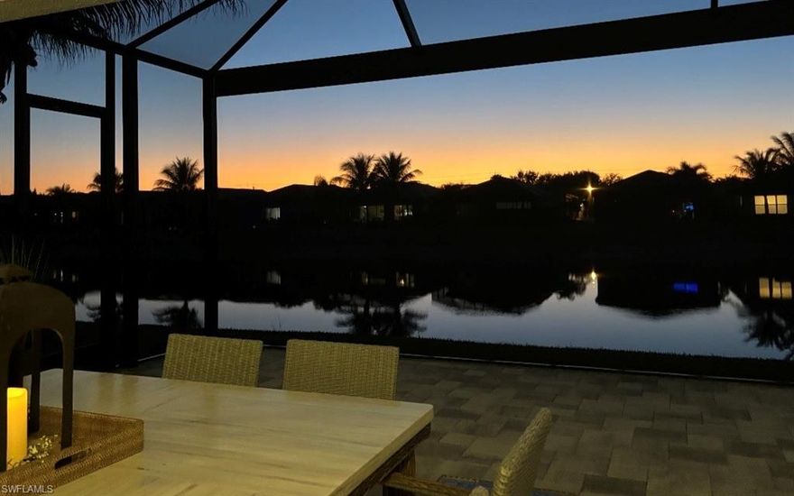 Experience refined Florida living in this exceptional lakefront residence located in the prestigious, gated community of Valencia Bonita. Built in 2021 and thoughtfully designed with the sought-after Tribeca floor plan by GL Homes, this custom single-family home captures stunning water views and unforgettable sunset skies through its picture-window screened lanai and expansive outdoor living space.

Inside, you’ll find a bright, open-concept design highlighted by soaring ceilings, abundant natural light, and sophisticated accent lighting that creates a warm yet elegant atmosphere. The living area flows seamlessly to the covered lanai, making this home ideal for both entertaining and everyday enjoyment.

The chef-inspired kitchen is beautifully appointed with premium upgraded appliances, quartz countertops, pull-out cabinetry, and generous bar seating. A versatile formal dining room offers flexibility as either an elegant dining space or a welcoming gathering area.

This home features 3 bedrooms, 2.5 baths, plus a den/office. The owner’s suite is a private retreat with tranquil lake views and a spa-style bathroom complete with dual vanities, a dedicated makeup area, and two custom walk-in closets.

Notable upgrades include a Wi-Fi-enabled whole-house generator, impact-rated windows and doors, Wi-Fi-controlled electric hurricane screens for the lanai, and an insulated Wi-Fi-enabled garage door with granite epoxy flooring and overhead storage. The outdoor living area is enhanced by a professional 10’ summer kitchen with sink, wine cooler, high-end grill, and granite countertops—all overlooking the serene lake through a panoramic picture screen enclosure.

Additional features include a tankless water heater, whole-house water filtration system, alarm system, and natural gas. The home is located in a no-flood zone and carries no CDD fees, offering both peace of mind and long-term value.

Valencia Bonita is renowned for its vibrant, resort-style lifestyle and exceptional amenities. The impressive 45,000-square-foot clubhouse includes a restaurant and bar, social hall, spa and nail salon, fitness center, billiards and card rooms, pottery and cooking studios, and four pools with cabanas and a hot tub. Outdoor recreation abounds with eight tennis courts, eight pickleball courts, and two bocce courts, along with a pro shop, dog park, and a full calendar of social clubs led by a full-time lifestyle director.

Ideally situated near the beaches of Naples, Bonita Springs, and Fort Myers Beach, as well as shopping, dining, arts, and the international airport, this home offers the perfect blend of luxury, convenience, and active 55+ resort-style living.