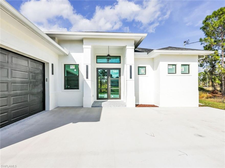 MOVE-IN READY! Experience modern Florida luxury in this beautifully designed 3-bedroom, 2-bath home offering 1,633 sq. ft. under air and 2,457 total sq. ft.

This home features pristine interiors with a bright, open-concept layout, high and coffered ceilings, an elegant accent wall with an electric heated fireplace. Enjoy 36” x 36” tile flooring throughout for a sleek, contemporary feel.

The gourmet kitchen is equipped with stone countertops, tall custom cabinetry, stainless steel appliances, a spacious pantry, and washer and dryer included.

The primary suite offers a true retreat with dual walk-in closets and a spa-like bathroom featuring separate vanities, and a large walk-in shower.

Additional features include impact windows and doors, a full laundry room, epoxy-coated garage floors, an extra large two car garage, a side garage access door with a large window, and a sprinkler system.

Step outside to an expansive covered back porch under trusses, nearly the full width of the home—perfect for entertaining and offering ample space for a future pool.

Located in a welcoming and growing community, this property delivers exceptional comfort, quality, and value.