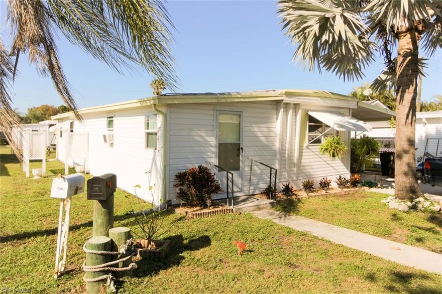 Enjoy quality and affordable living here in Mobile Manor where you own your land (no lot rent in this community)! This 2/1 with a den (could be used as 3rd bedroom) has been remodeled inside and out. Beautifully decorated (think HGTV remodel)! If you are looking for a park-like setting without the high fees and rules, you need to check this home out! The home now has a very modern feel. Drywall was installed and the floor coverings updated. The kitchen features stainless appliances, white cabinets and a nice counter-top. Inside the laundry room is a plus. Master bedroom has its own entrance. New plumbing and electrical and the roof is in good condition per the Seller. The unit has duct-work for a package unit HVAC system. The owner preferred to have wall units to cool the home. There is a large screen in porch with a small shed. The community amenities include a BBQ area, shuffleboard, gaming tables, and a large kitchen. Mobile Manor is a voluntary HOA with very low fees!