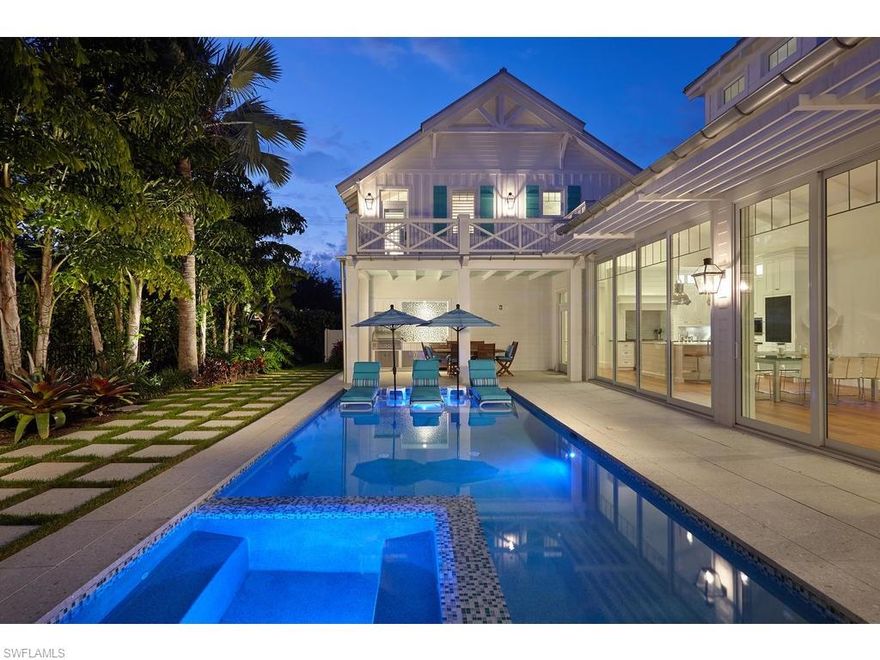 This custom home is the epitome of beauty and grace. Located on one of Old Naples’ most charming streets and just steps to the renowned sugar sand beaches of the Gulf of Mexico, this home is perfect for entertaining. The great room concept features a chef's kitchen that opens to the dining and living space. The timeless architecture is accented with custom landscaping & lighting design, Old Chicago Brick, Zoysia grass, mature palms and a picket fence. The home's interior features include one of a kind reclaimed Heart Pine floors, tongue & groove ceilings, custom millwork, polished nickel fixtures & hardware, top of the line gas & electric appliances, an oversized island with marble countertop, and inset cabinetry. The master suite offers two large walk-in closets, and large master bathroom giving it a spa-like feel. Tall sliding glass doors allow for effortless indoor/outdoor living. The expansive outdoor living space features a large saltwater pool and spa with an outdoor fireplace, dining area, and outdoor kitchen. With an attached three car garage off of an alley and options for two elevators, this home is luxurious Old Naples living at its best!