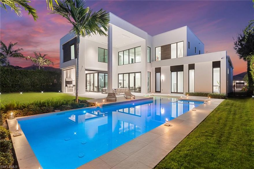 Perfectly positioned in the coveted Moorings neighborhood, this contemporary retreat masterfully balances form and function. Defined by clean architectural lines and sun-drenched interiors, the home embodies a minimalist’s ideal. Natural light pours across wide-plank oak floors, illuminating a gourmet kitchen outfitted with custom cabinetry and premium Wolf and Sub-Zero appliances—an elegant expression of understated luxury. Soaring ceilings amplify the home’s airy ambiance, while the easy flowing layout offers both privacy and flexibility. Dual primary suites—one on the main level and another upstairs—serve as serene sanctuaries, each featuring spa-inspired baths, dual walk-in closets, and convenient laundry access. Outdoors, a lush tropical backdrop framed by bamboo and a fruit-bearing mango tree sets the stage for the sleek modern pool and expansive yard—a private oasis ideal for quiet afternoons or stylish entertaining. With close proximity to downtown Naples and exclusive access to the Moorings Beach Park, this residence is the ideal full or part time residence.