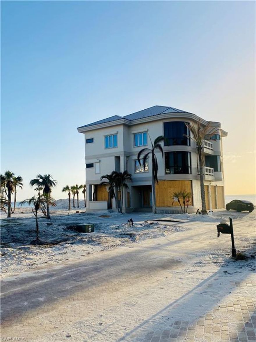 This rare Barefoot Beach 3 story home is a 1st position right on the beach! Includes lots 1 & 2 (equal to 4 standard lots).  All concrete construction, electric shutters, a garage that can hold a 40 ft motorhome or boat plus 3 large vehicles and toys, elevator, open floor plan with huge living areas, high volume ceilings, audio/video system, 4 bedrooms, 4.5 baths.  Lower level of home was damaged during Hurricane Ian.  Breakaway walls, garage doors, man doors, front door, windows, and interior drywall will need replaced at Buyer's expense.  Two living levels are in good condition with air conditioning running and no damage from the storm.